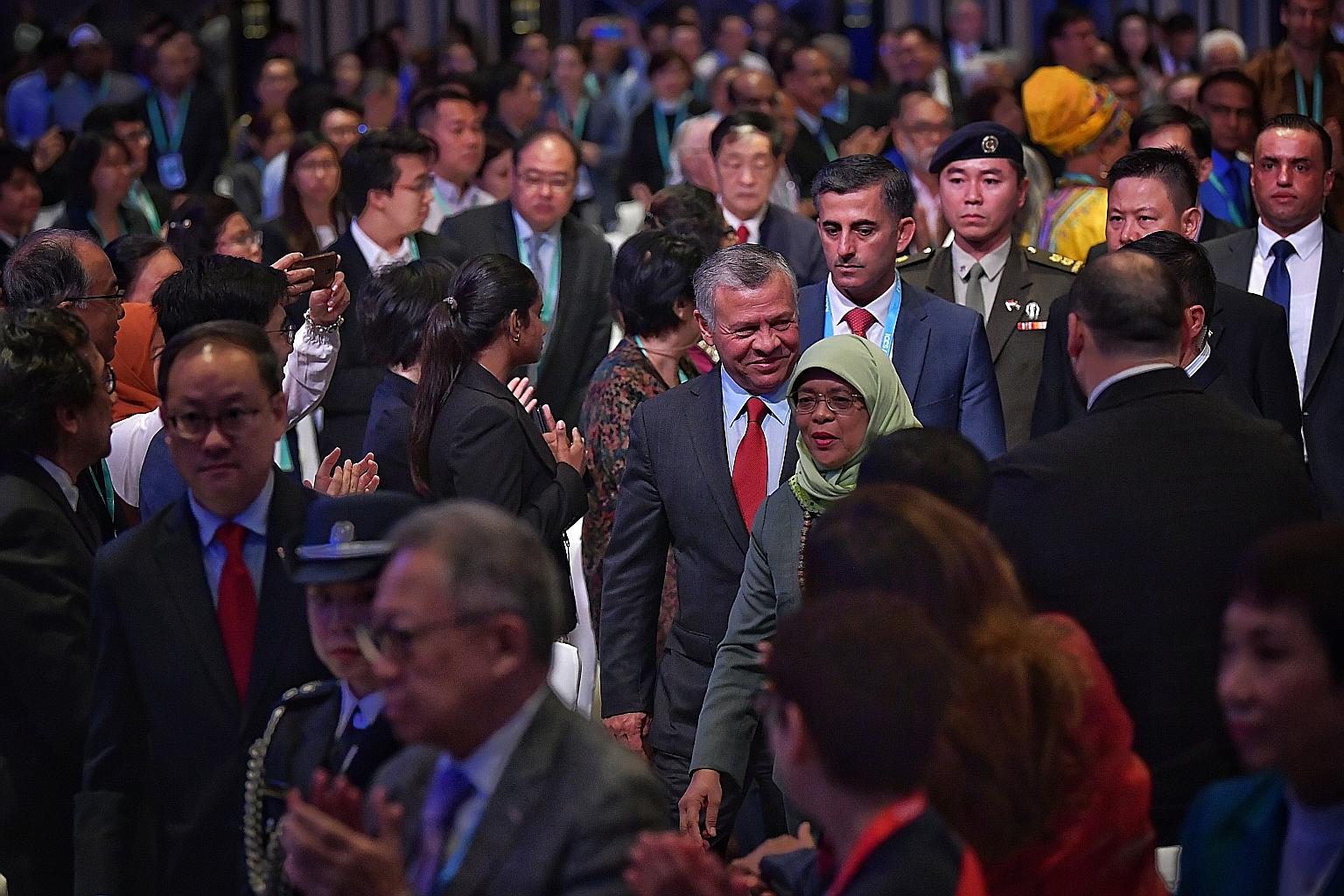 Jordan's King Abdullah II and President Halimah Yacob arriving at the inaugural International Conference on Cohesive Societies at the Raffles City Convention Centre yesterday. The King called on the billions of people who seek peace and harmony to ra
