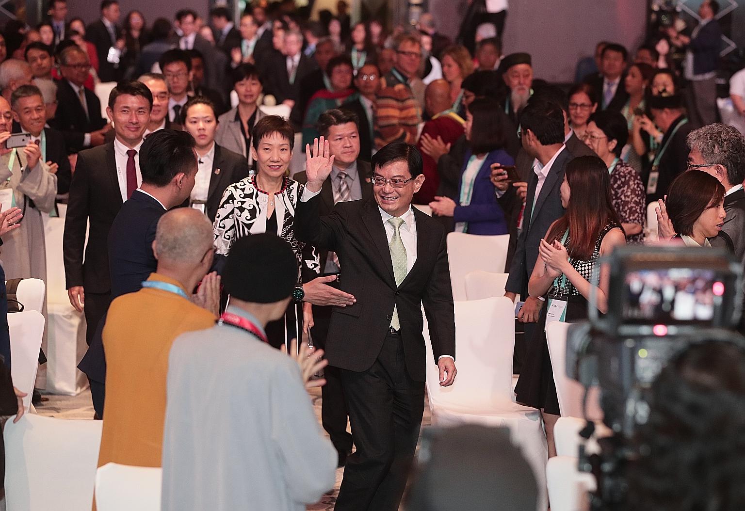 Deputy Prime Minister Heng Swee Keat arriving at the International Conference on Cohesive Societies yesterday with Minister for Culture, Community and Youth Grace Fu (beside him) and Senior Parliamentary Secretary for Culture, Community and Youth Bae