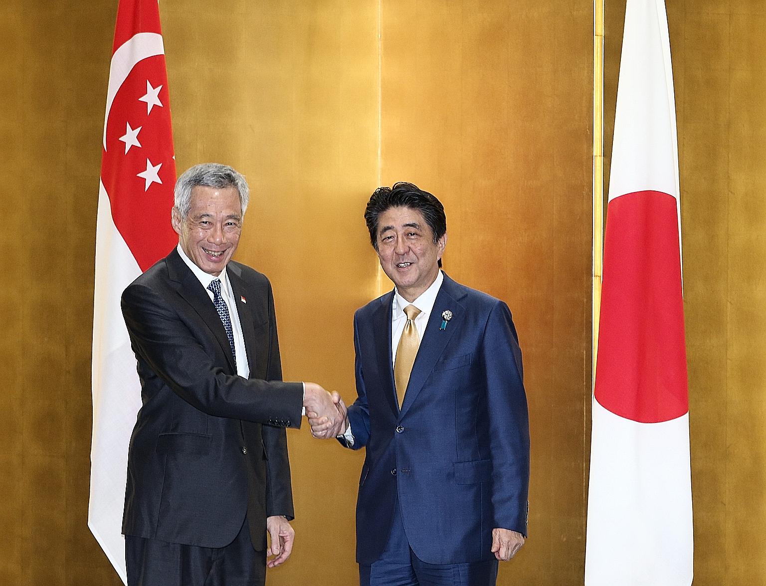 Prime Minister Lee Hsien Loong being welcomed by Japanese Prime Minister Shinzo Abe yesterday upon his arrival in Osaka. PM Lee is attending the Group of 20 Summit at the invitation of Mr Abe.