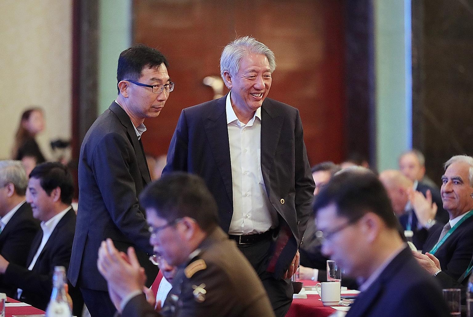 Senior Minister Teo Chee Hean, who is also Coordinating Minister for National Security, arriving at the second Singapore Defence Technology Summit at Shangri-La Hotel yesterday with the Defence Science and Technology Agency's chief executive Tan Peng