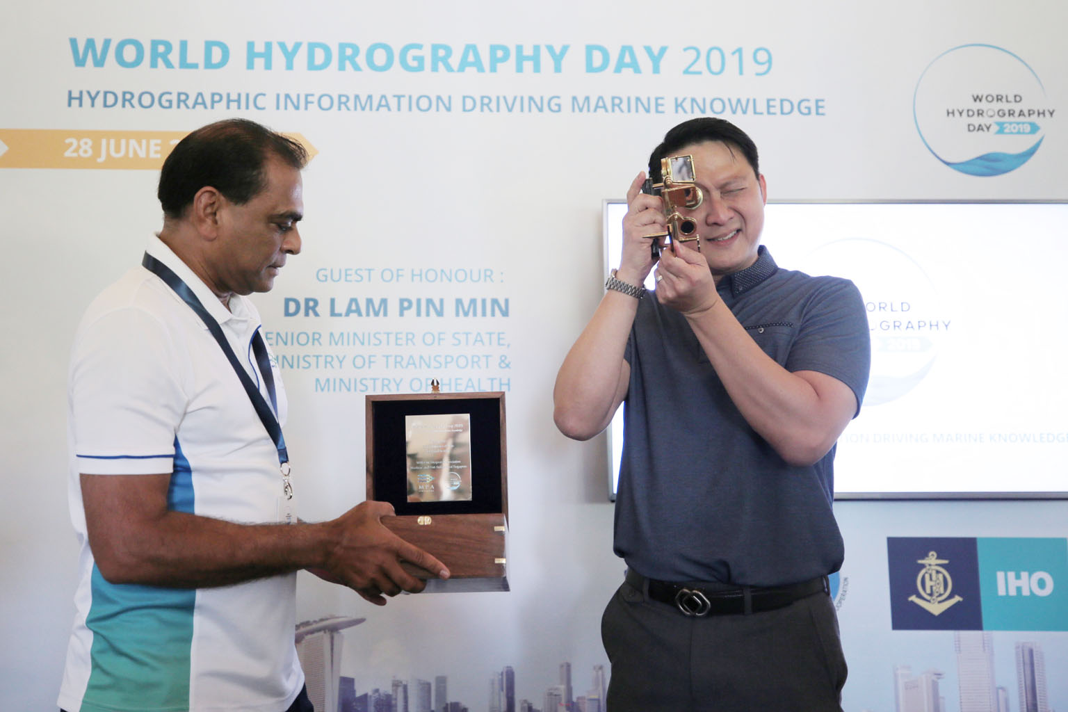 Senior Minister of State for Transport and Health Lam Pin Min trying out a sextant yesterday. With him is Maritime and Port Authority of Singapore assistant chief executive for operations, Captain M. Segar. ST PHOTO: JASON QUAH