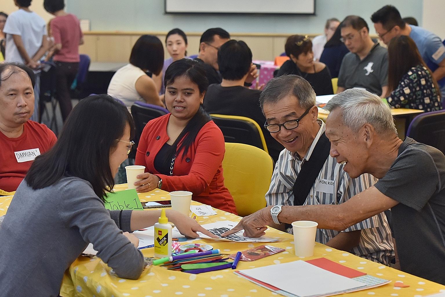 Speech therapist Koh Sze Khee, 29, in a Chit Chat Cafe session with Mr Foo Chai Keng (far right), 75, and Mr Cheong Hon Kee.