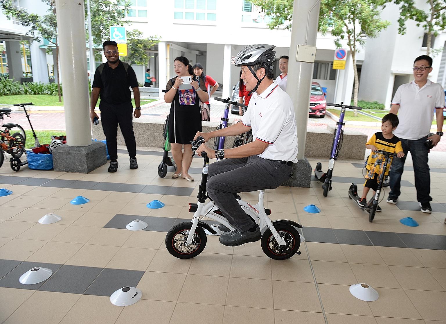 Minister in the Prime Minister's Office Ng Chee Meng taking part in a safe-riding activity at the Buangkok Fun Carnival yesterday. PHOTO: LIANHE ZAOBAO