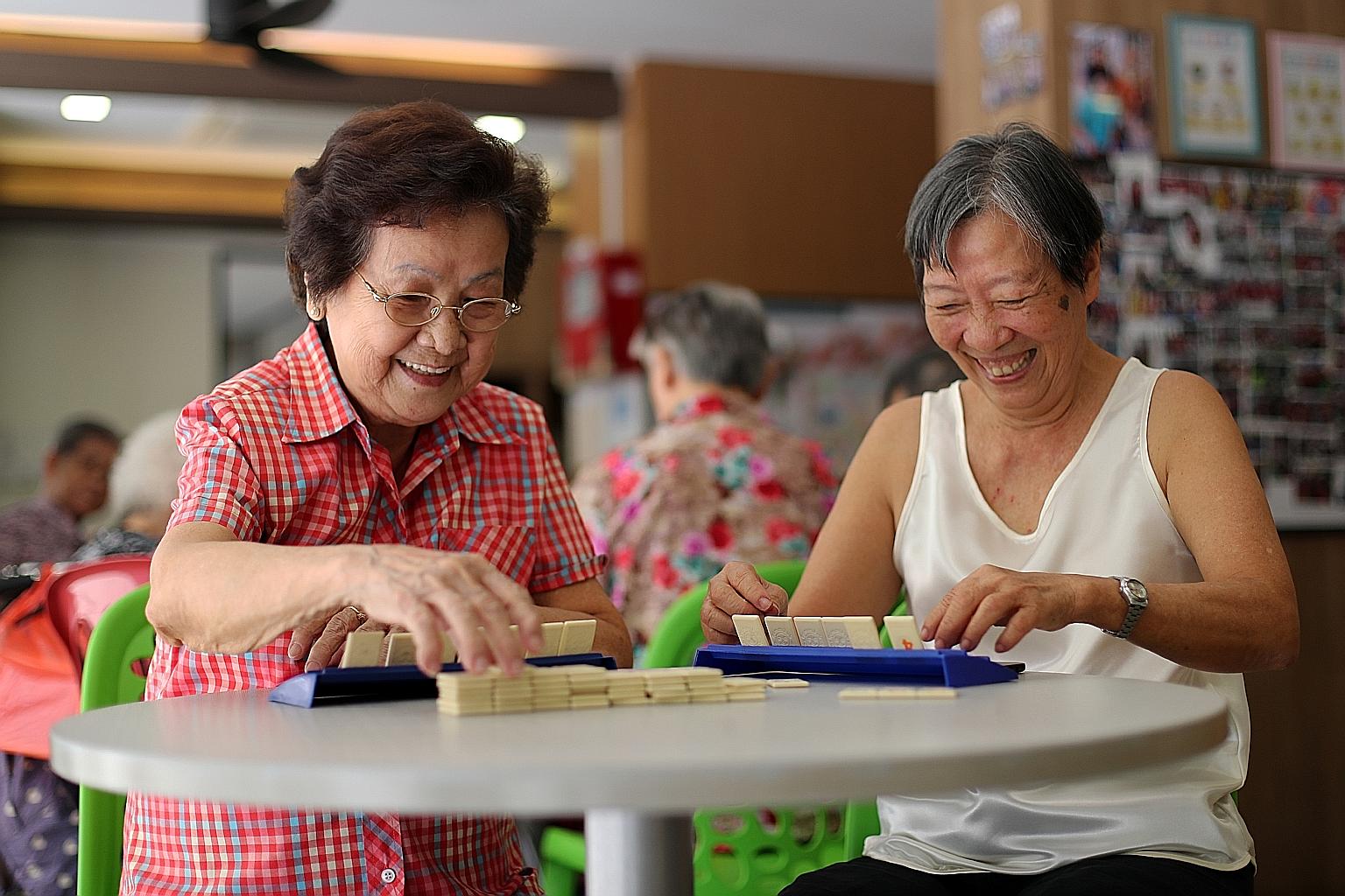 Madam Tsang Sow Kuen (in red) and Madam Tan Lu See having a game of Rummikub at the Wellness Kampung Senior Activity Centre on Thursday. For the two seniors, making their last wishes known - so their children know what to do when the time comes - is