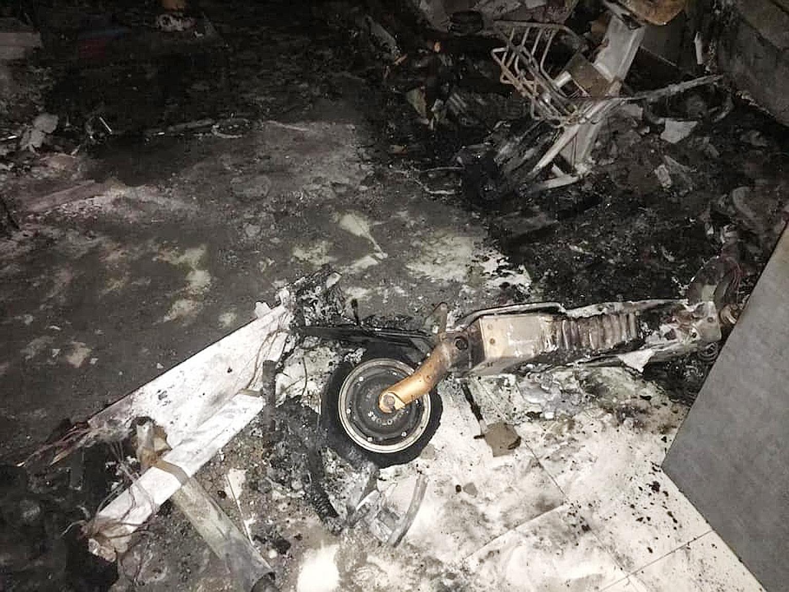 The fire in the living room (left) of a unit on the 26th floor of Block 293D Bukit Batok Street 21 was traced to two e-scooters (above). An unconscious man with burn injuries and a woman who suffered smoke inhalation were taken to hospital.