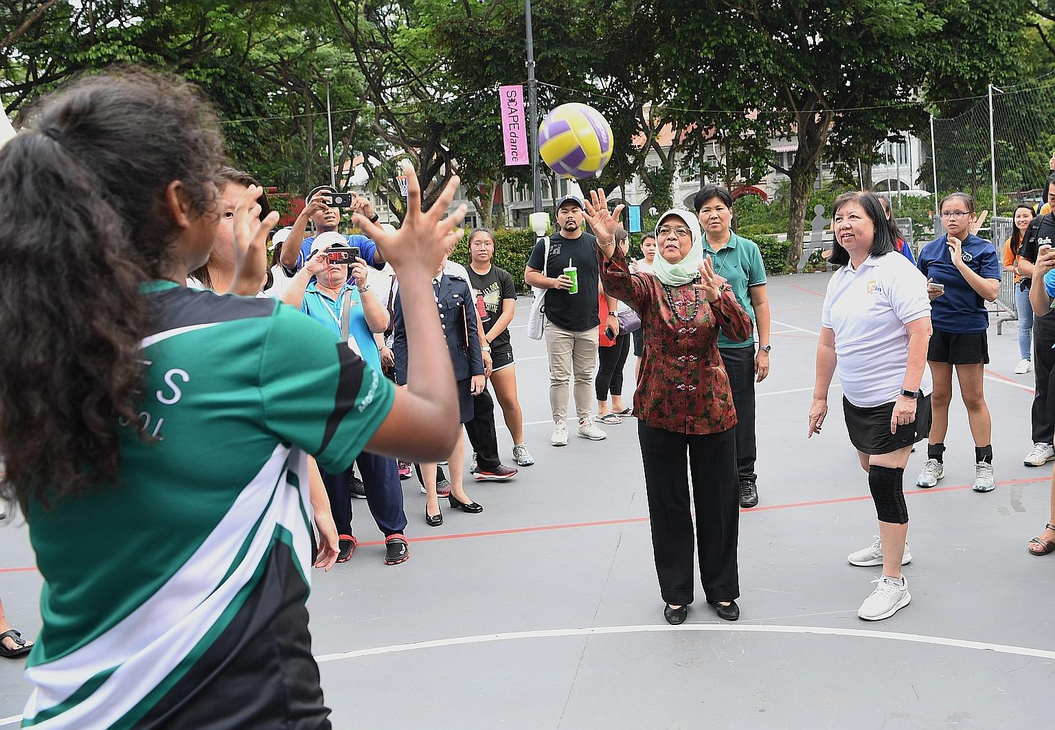 President Halimah Yacob taking part in a netball game at an event in support of the President's Challenge Volunteer Drive 2019 at *Scape yesterday. The President's Challenge has rallied over 6,000 volunteers since the start of the year, more than 80 
