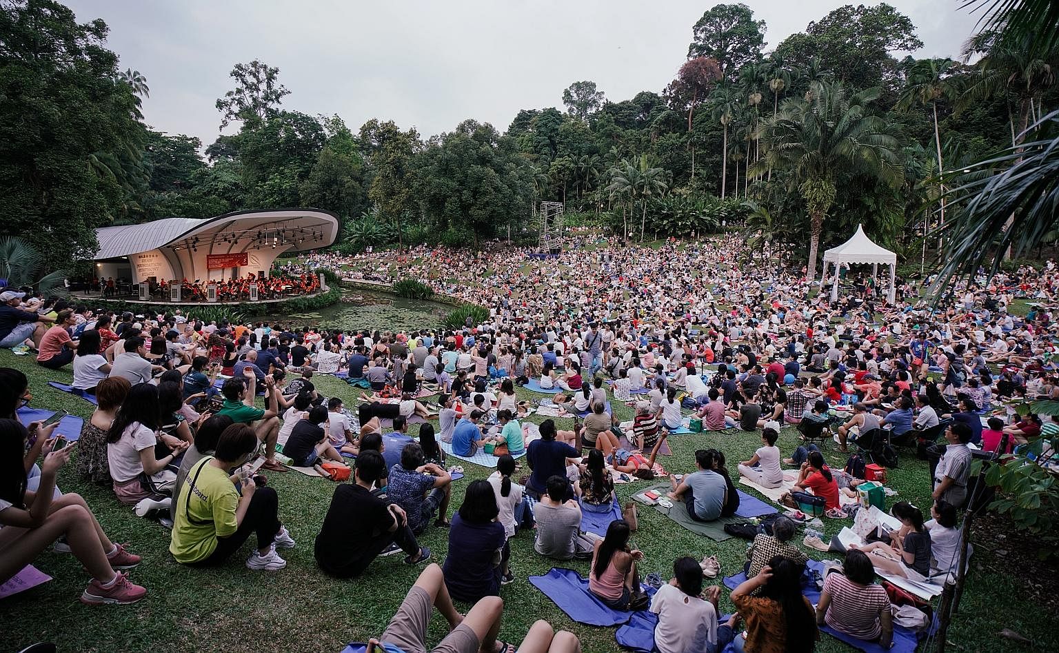 Music filled the air at the Botanic Gardens yesterday as the Singapore Symphony Orchestra (SSO) played to thousands who attended The Straits Times Concert in the Gardens. The SSO, led by associate conductor Joshua Tan, performed a selection of family