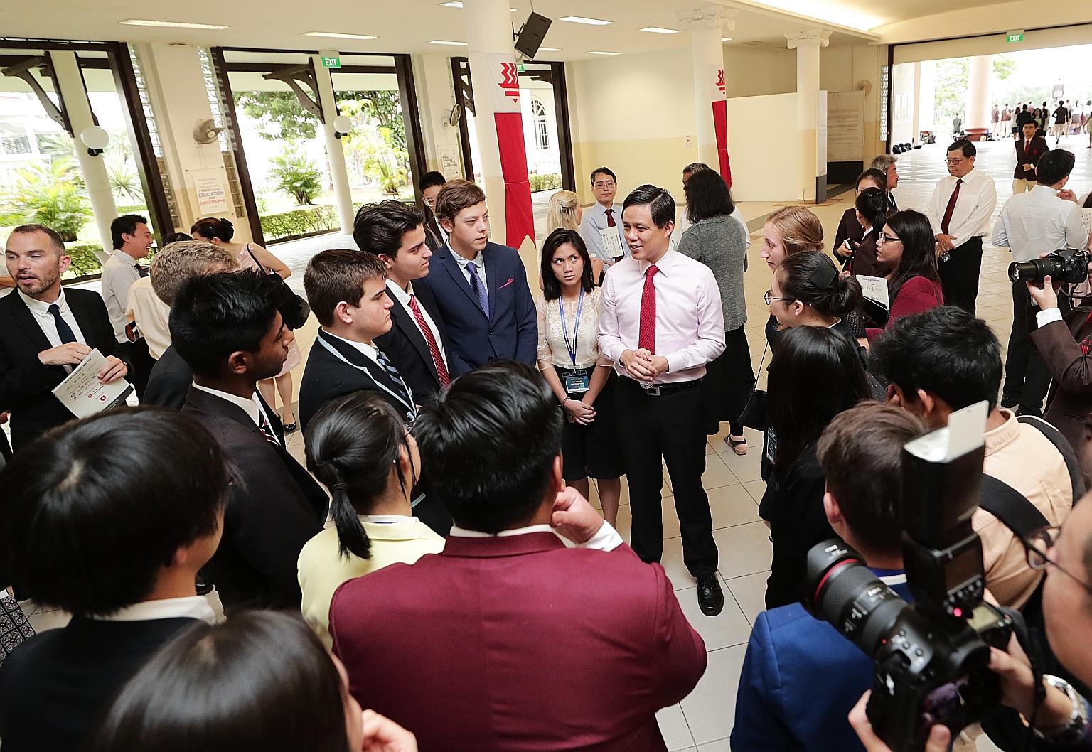 Trade and Industry Minister Chan Chun Sing chatting with students and teachers from 27 schools from across the world yesterday at the opening of the annual Hwa Chong Asia Pacific Young Leaders Summit. The student leaders will visit key institutions h