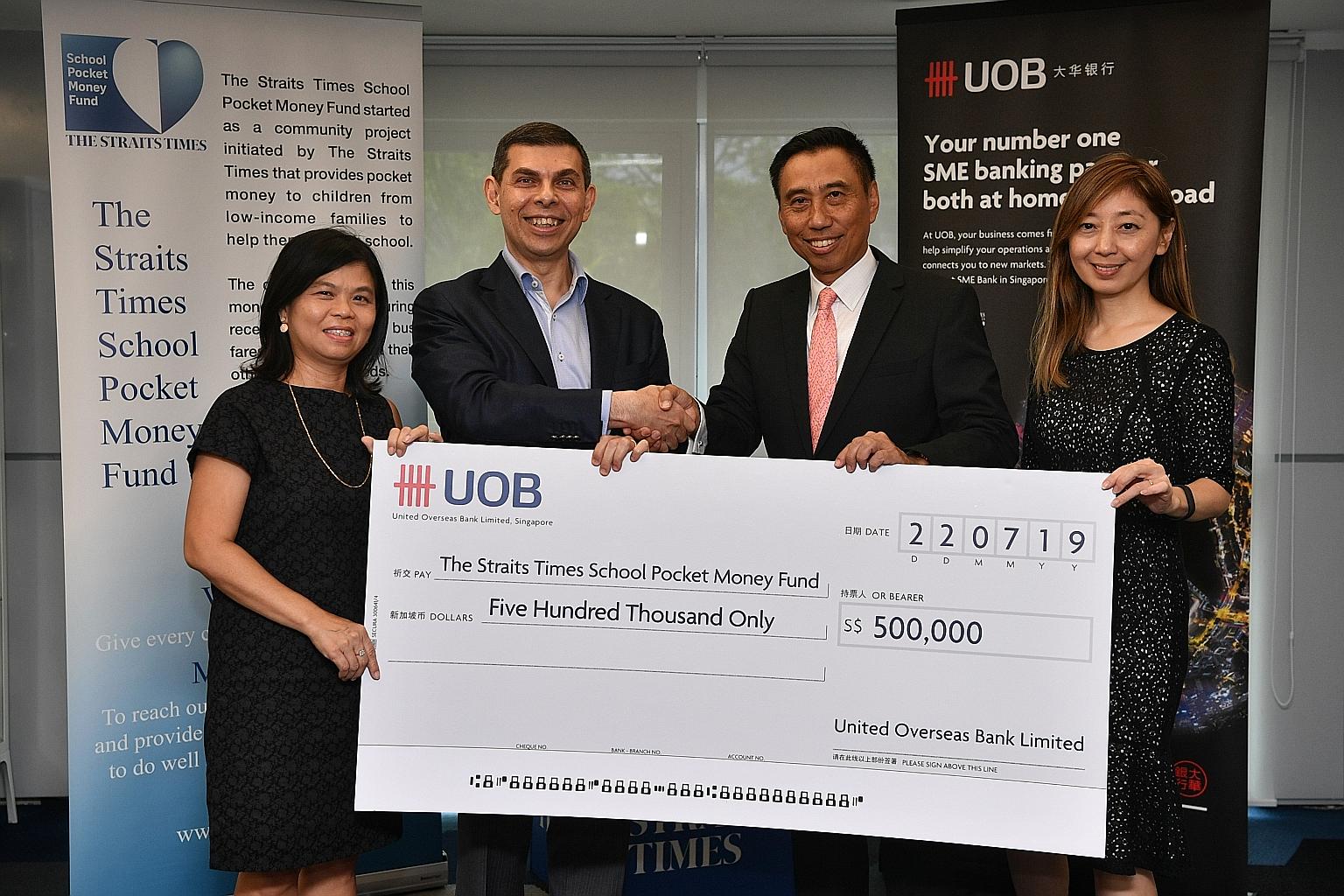 UOB Group Commercial Banking head Eric Tham (second from right) presenting a cheque for $500,000 to ST School Pocket Money Fund (STSPMF) chairman and ST editor Warren Fernandez. With them are STSPMF general manager Tan Bee Heong (far left) and ST exe