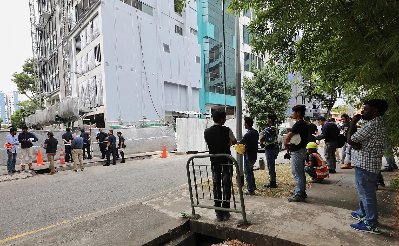 Above: The area where a suspected World War II bomb was found, on the grounds of a half-constructed building in Geylang Lorong 23, was cordoned off after its discovery yesterday. The safety officer of the construction site confirmed that the object w