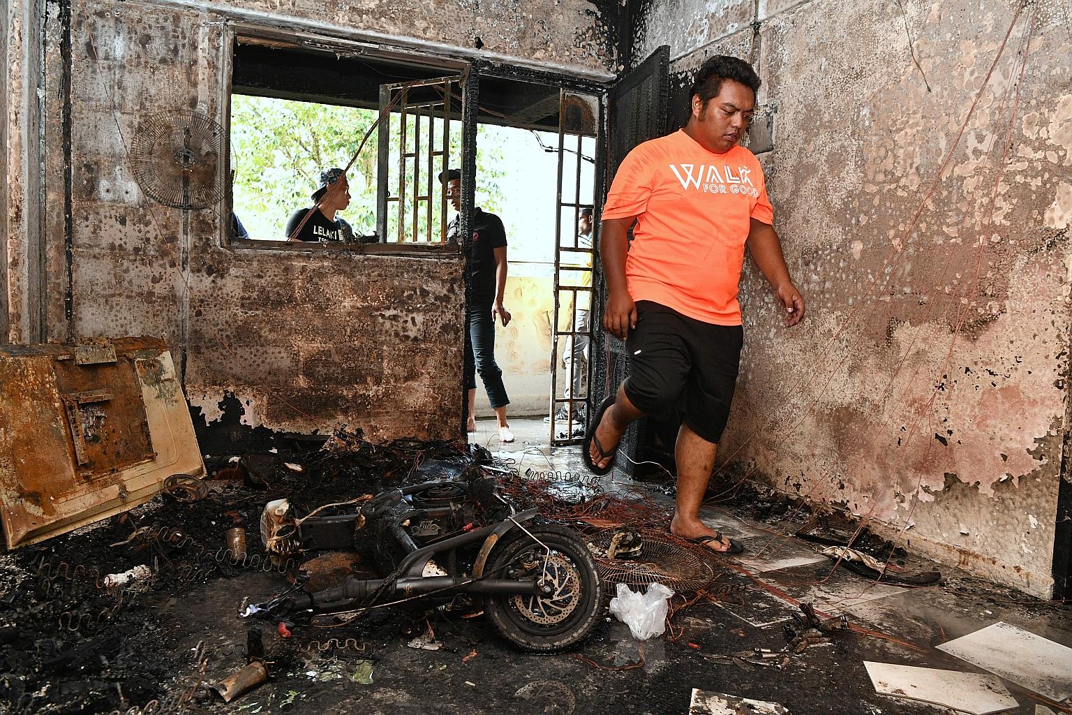 The blackened interior of a flat at Block 224 Ang Mo Kio Avenue 1 after a fire broke out on Monday. The blaze is believed to have been caused by the overcharging of an electric scooter.