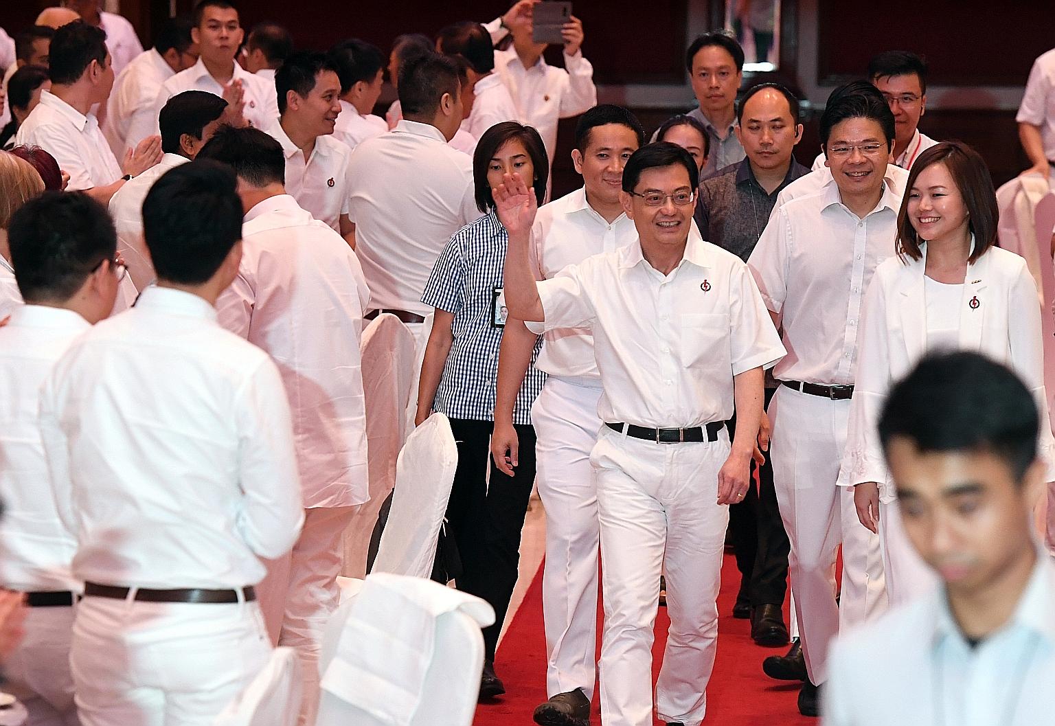 Deputy Prime Minister Heng Swee Keat greeting party activists on arrival at the People's Action Party Policy Forum's 15th anniversary dinner last night. With him are Senior Parliamentary Secretary for Home Affairs and Health Amrin Amin, Minister for