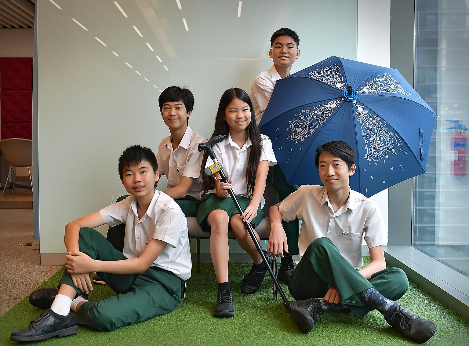 The young entrepreneurs running Qanemate are (clockwise from left) Yuan Jing Shuo, siblings Seng Ian Hao and Seng Ing Le, Brian Tan and Coen Yap. Besides the walking stick holder, the firm is also behind the QaneBrella.