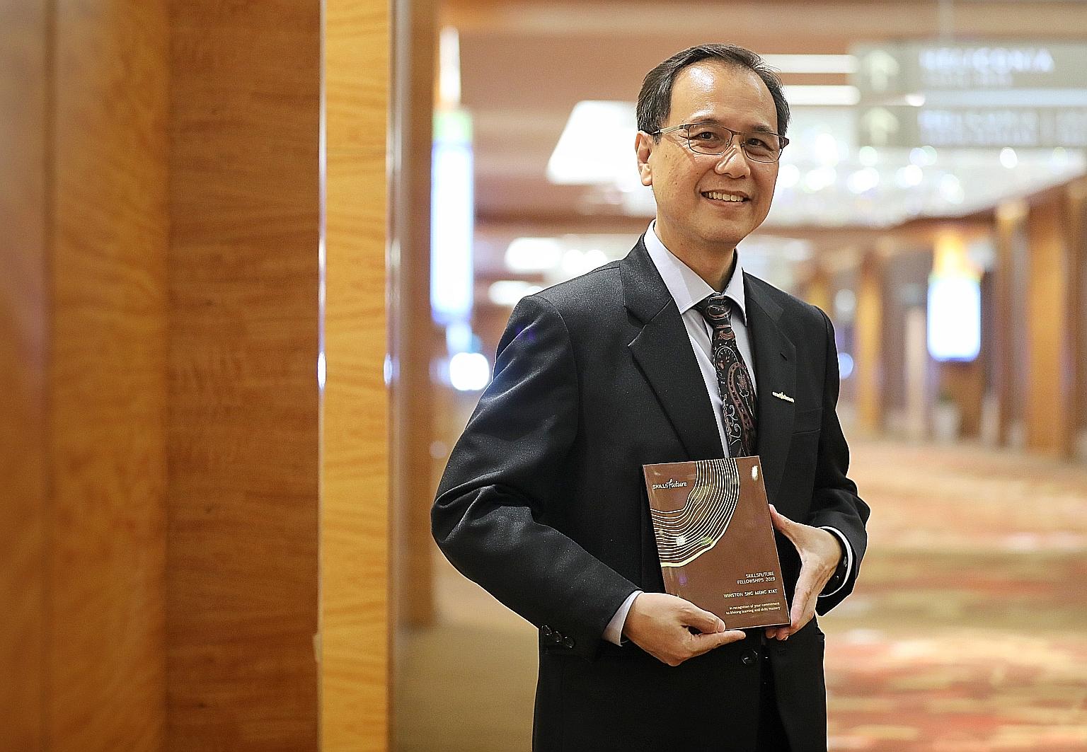 Mr Winston Sng, a senior human resource manager at the United Test and Assembly Centre, with his SkillsFuture Fellowships award at the SkillsFuture Fellowships and SkillsFuture Employer Awards ceremony at Marina Bay Sands yesterday.