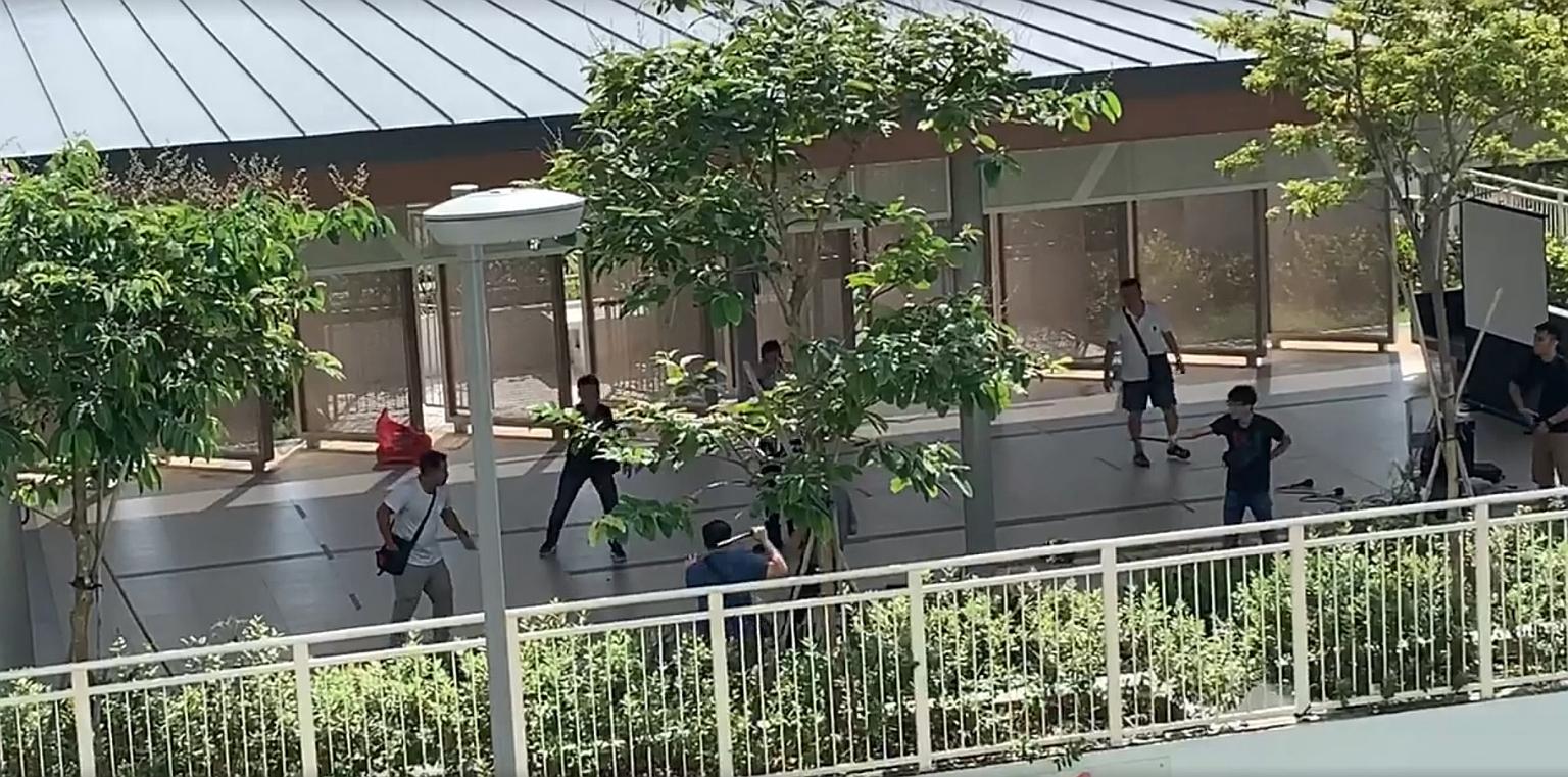 A screengrab from a video circulating on social media showing a knife-wielding man being surrounded by police officers in Woodlands Rise on Monday. The man, who was arrested, is suspected of being involved in a theft case.