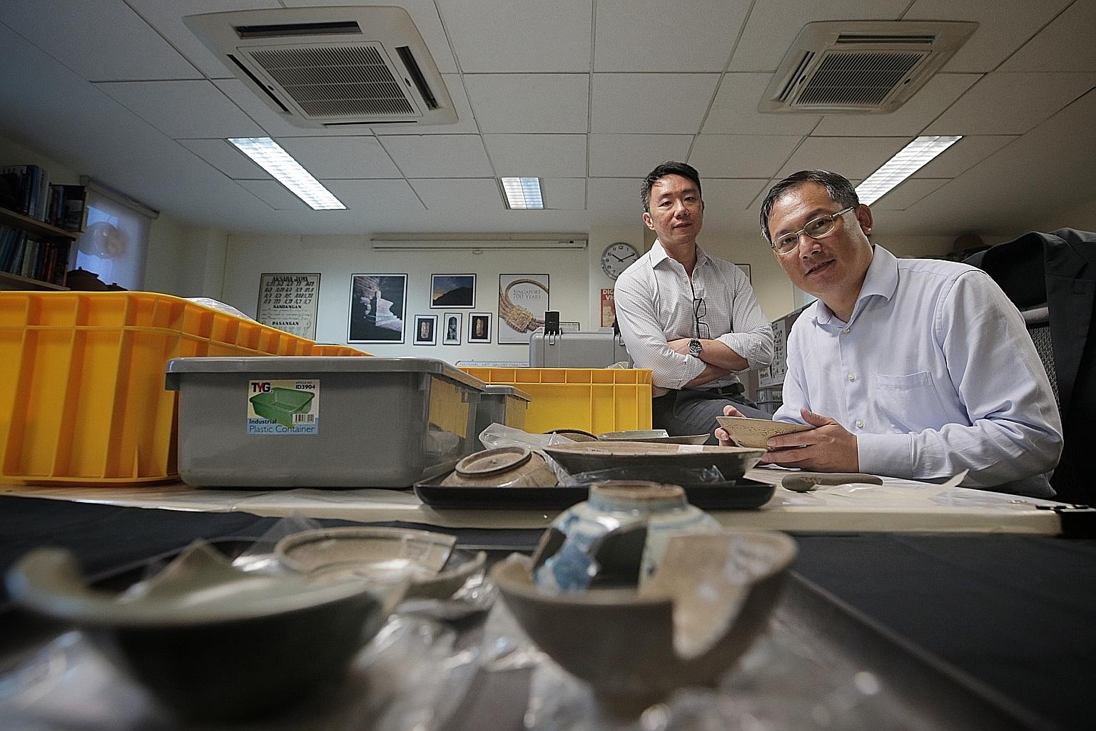 Dr Terence Chong (left), head of the Temasek History Research Centre, and archaeologist Tai Yew Seng, a visiting fellow at the centre, with artefacts from the Empress Place excavation. The centre will get $400,000 a year from the Temasek Foundation f