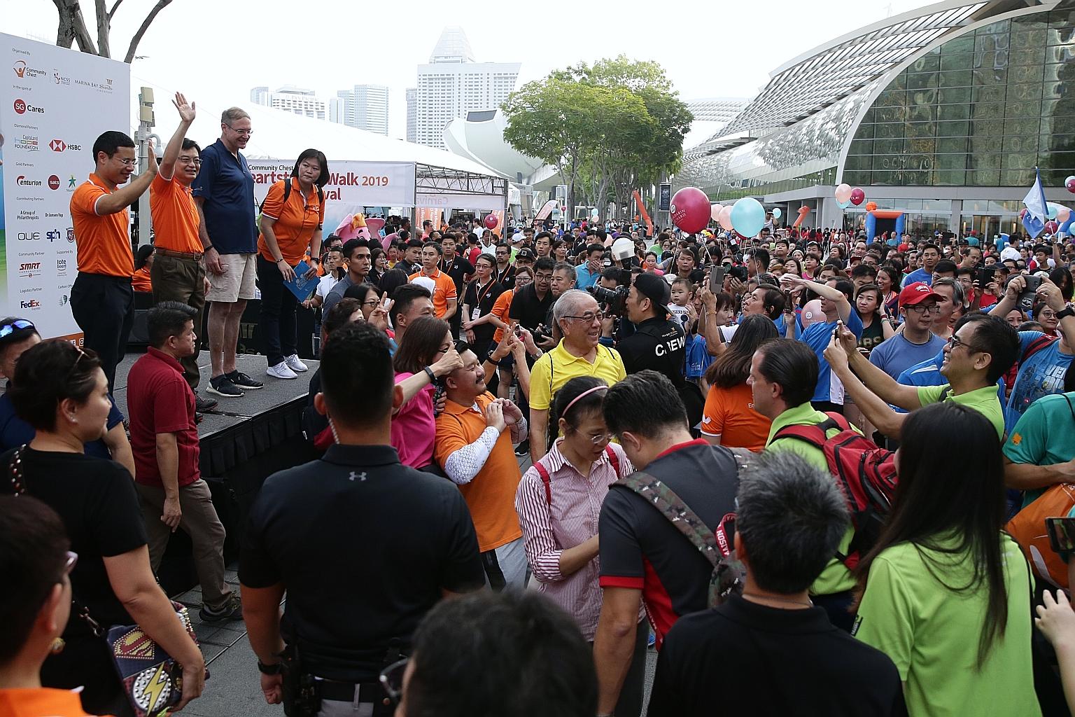 Deputy Prime Minister Heng Swee Keat (second from left) with Minister for Social and Family Development Desmond Lee at yesterday's Community Chest Heartstrings Walk, which saw participants stroll through a 4km bicentennial-themed route around Marina 