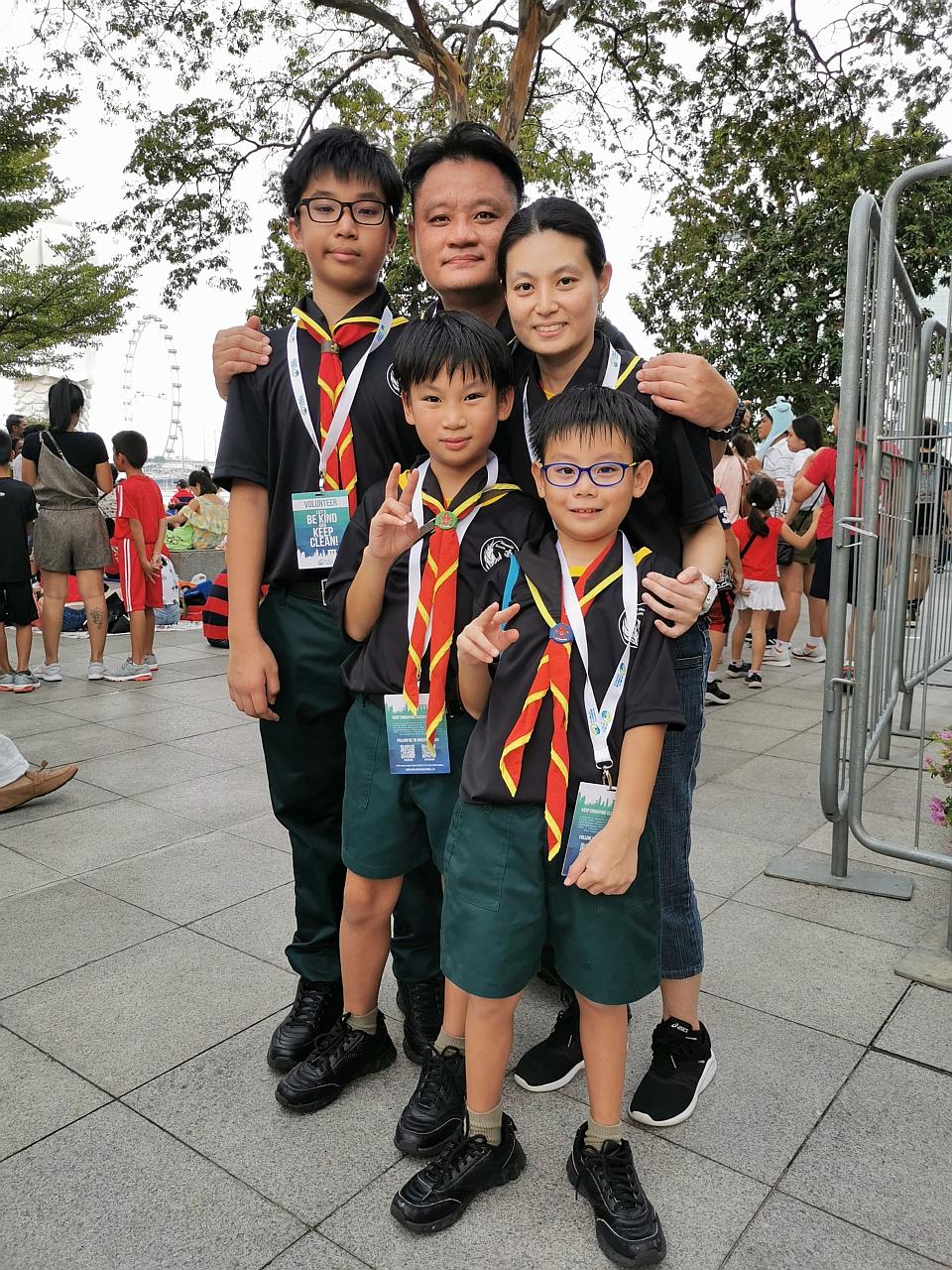 Mr Caleb Teo, his wife, Ms Shu Yi Ping, 41, and their sons (from left) Isaiah, Zechariah and Jedidiah went to the Padang area not to catch the NDP but to help keep the place litter-free. PHOTO: NATIONAL ENVIRONMENT AGENCY