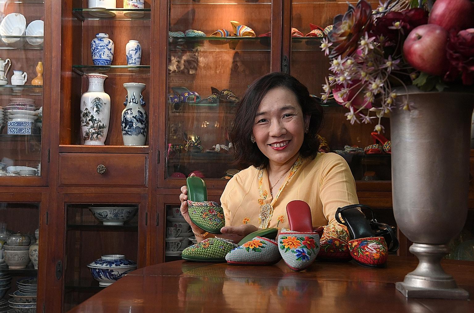 Ms Angeline Kong with her great-grand-aunt's green kasut manek (Peranakan beaded shoes) and two newer pairs that she made herself. ST PHOTO: DESMOND FOO