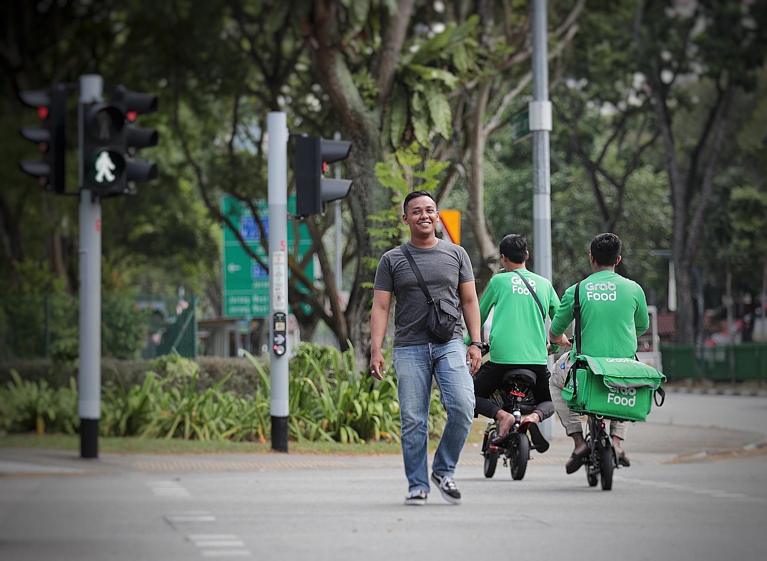 Many netizens have praised food delivery rider Muhammad Riau Alfian (far left) for rescuing a trapped truck driver (left) on Saturday. PHOTOS: GIN TAY, RYAN HIROSHI/ FACEBOOK