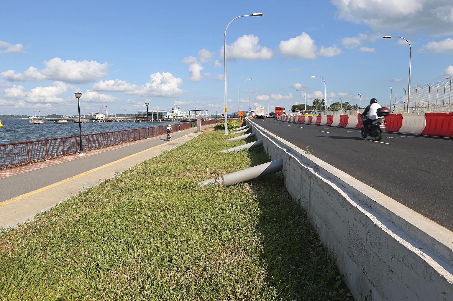 In this file photo from 2016, a stretch of Nicoll Drive, next to Changi Beach, is shown freshly elevated to prepare for rising sea levels due to climate change.
