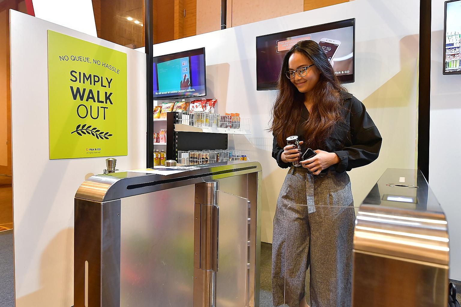 A guest at the Singapore Retail Industry Conference and Exhibition 2019 using an unmanned booth by Pick & Go. The booth eliminates the need for cashiers, with shoppers paying for their purchases by tapping in and out of gateways.