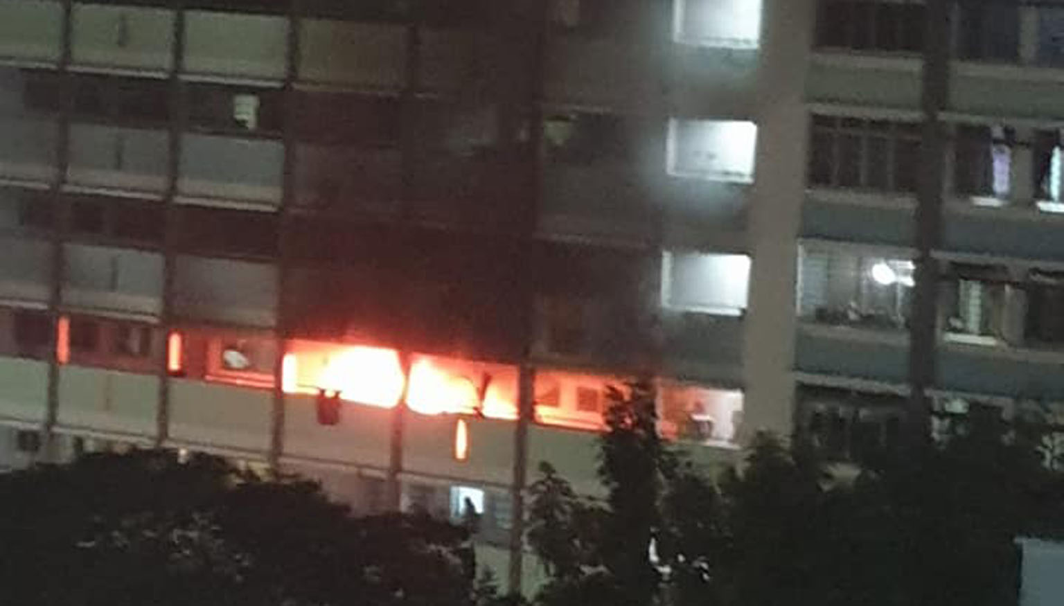 Thick plumes of smoke from a fire at a Jurong West Housing Board flat on Sunday. The SCDF rescued a woman from the flat's kitchen ledge, and she and three others were taken to hospital.
