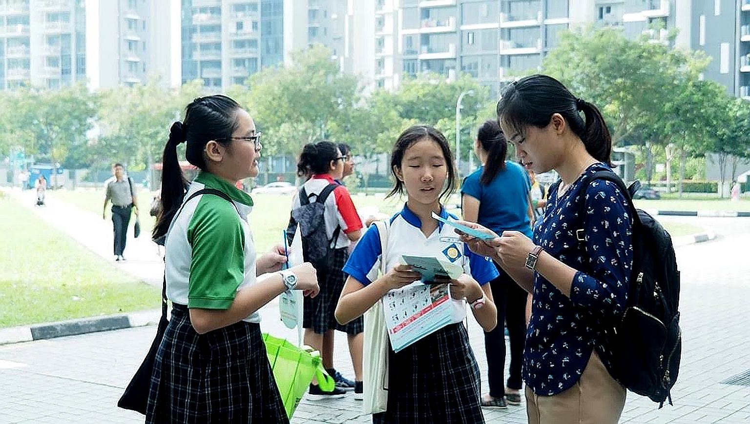 Seng Kang Primary pupils conducting an outreach session in their neighbourhood last October as part of a campaign about the proper usage of shared bicycles. The project won the top prize in the schools category of the Land Transport Authority's Activ