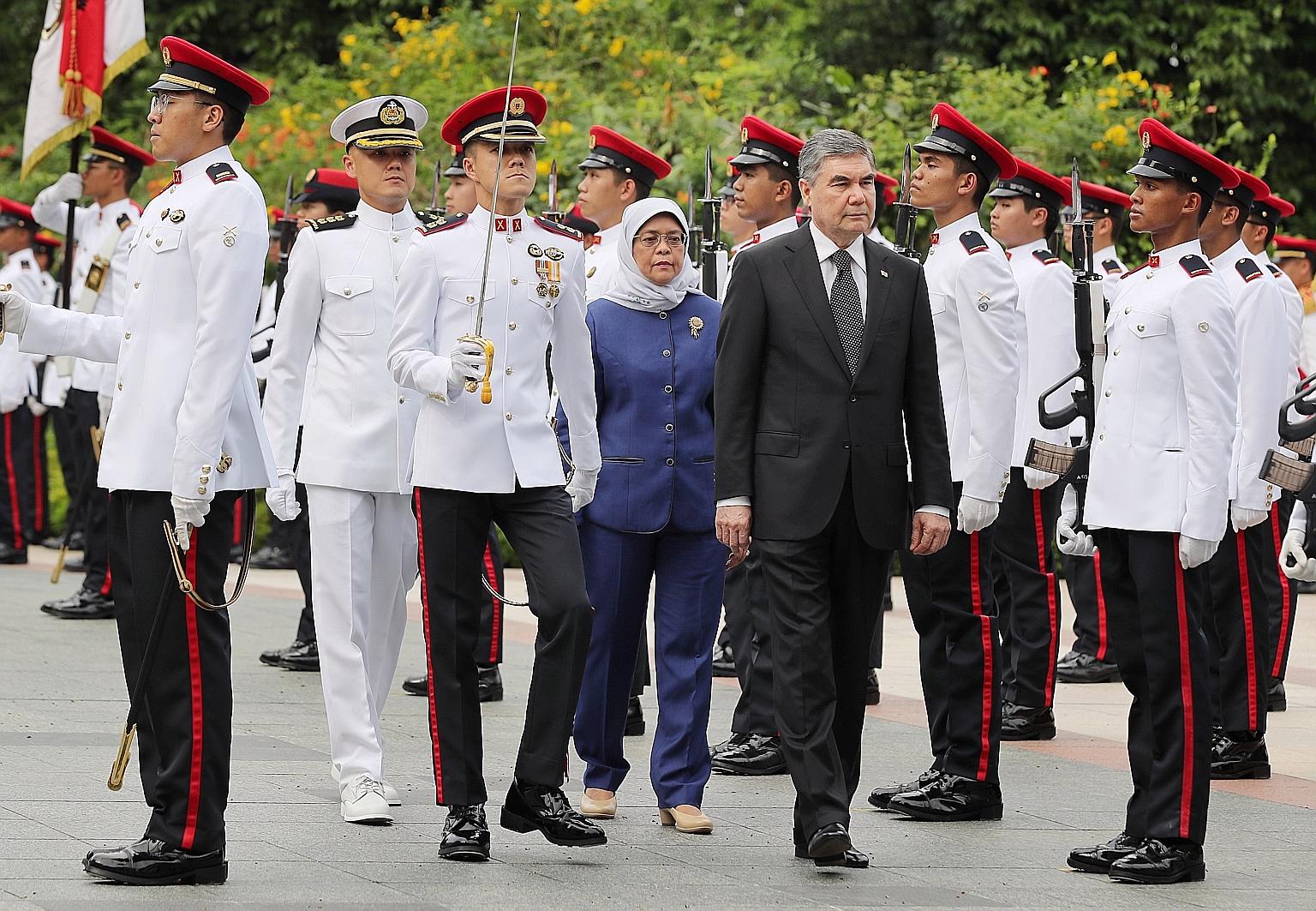 Turkmenistan President Gurbanguly Berdimuhammedow, accompanied by Singapore President Halimah Yacob, reviewing the guard of honour at the Istana yesterday. He left Singapore last night.