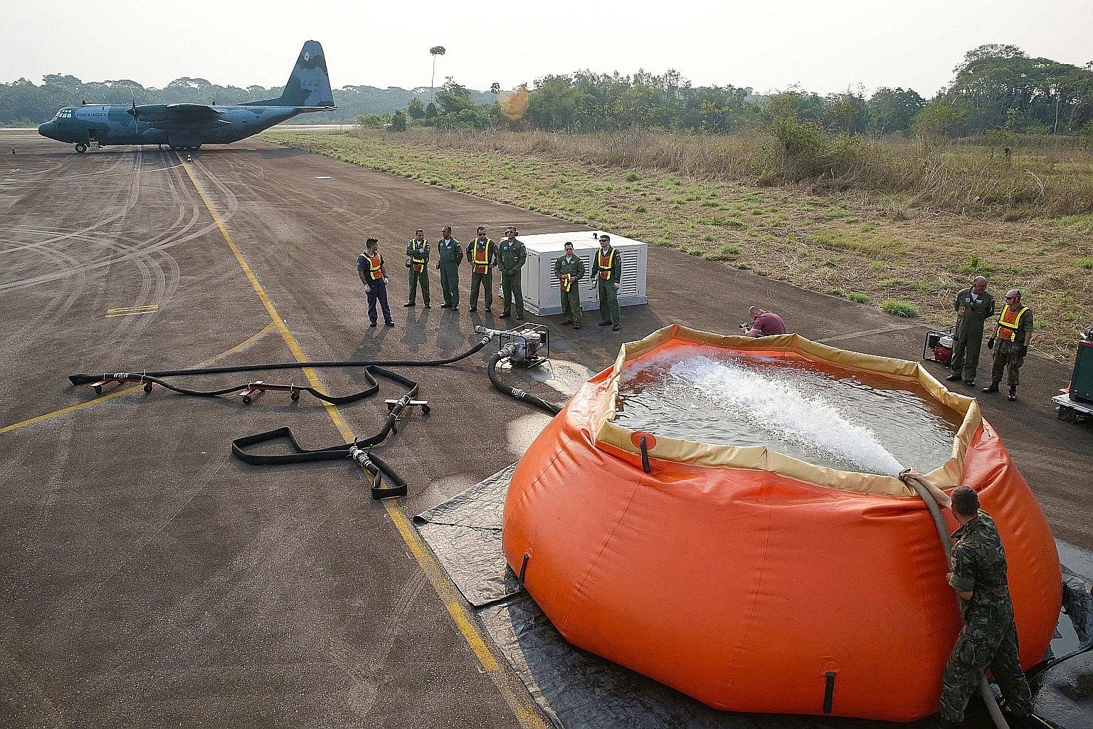 A Hercules C-130 aircraft of the Brazilian Air Force waiting to collect giant water bags to fight fires in the Amazon rainforest, in the state of Rondonia, one of the states most affected by the wildfire crisis. About 60 per cent of the Amazon is in 