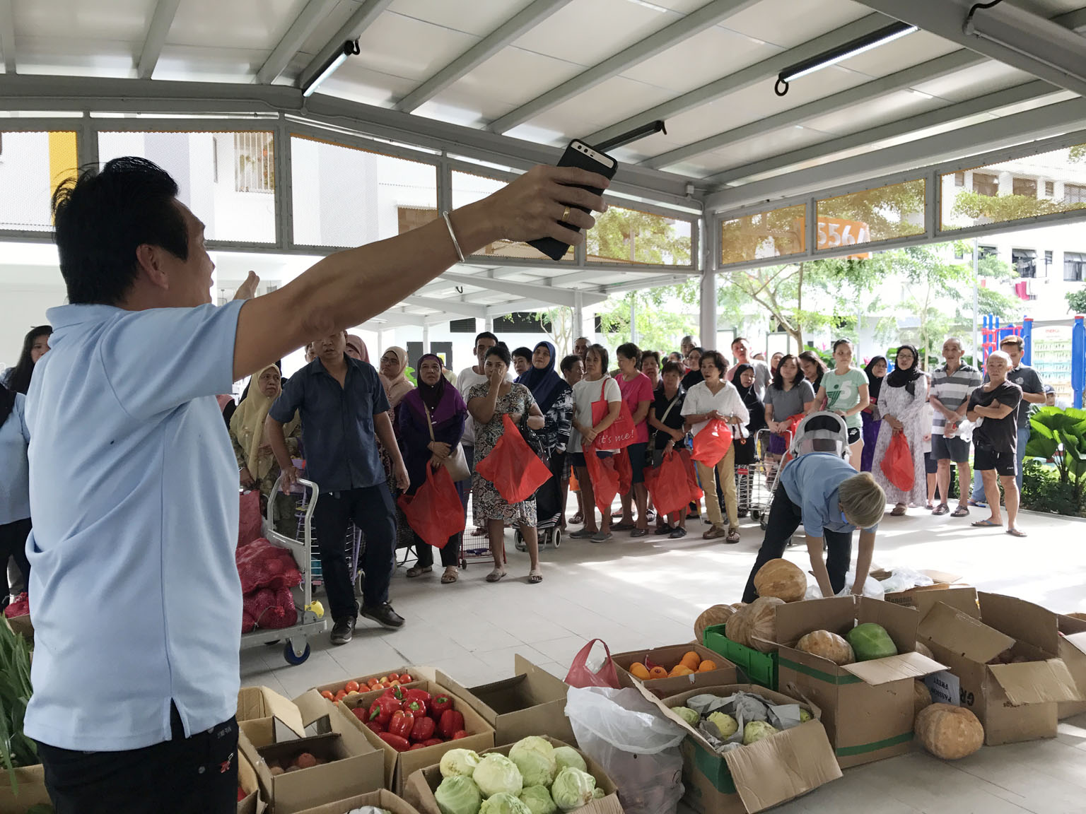 People waiting for the distribution of produce by The Food Bank Singapore. A Singapore Food Agency spokesman says Good Samaritan laws are being explored here. This could give businesses more protection when they donate food, and could raise the amoun