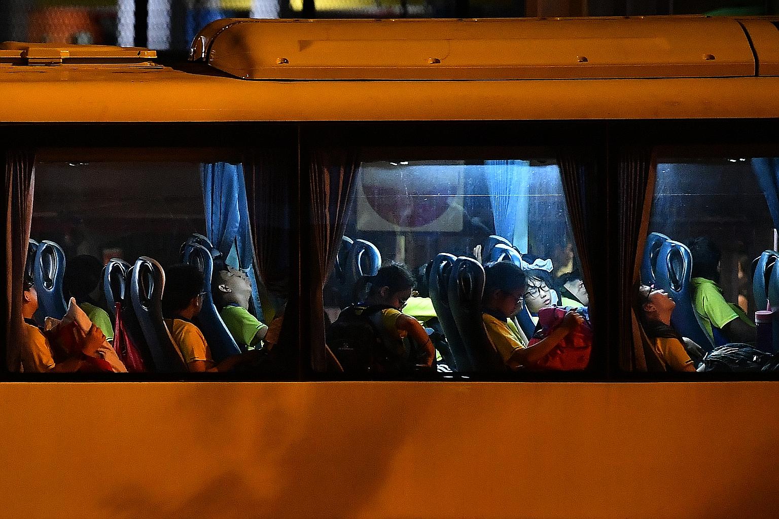 Punggol Primary School pupils returning to the school on Friday, the second day of a three-day camp at Dairy Farm Outdoor Adventure Learning Centre. The school decided to end the camp early after participants were hit by diarrhoea and stomach pain. S