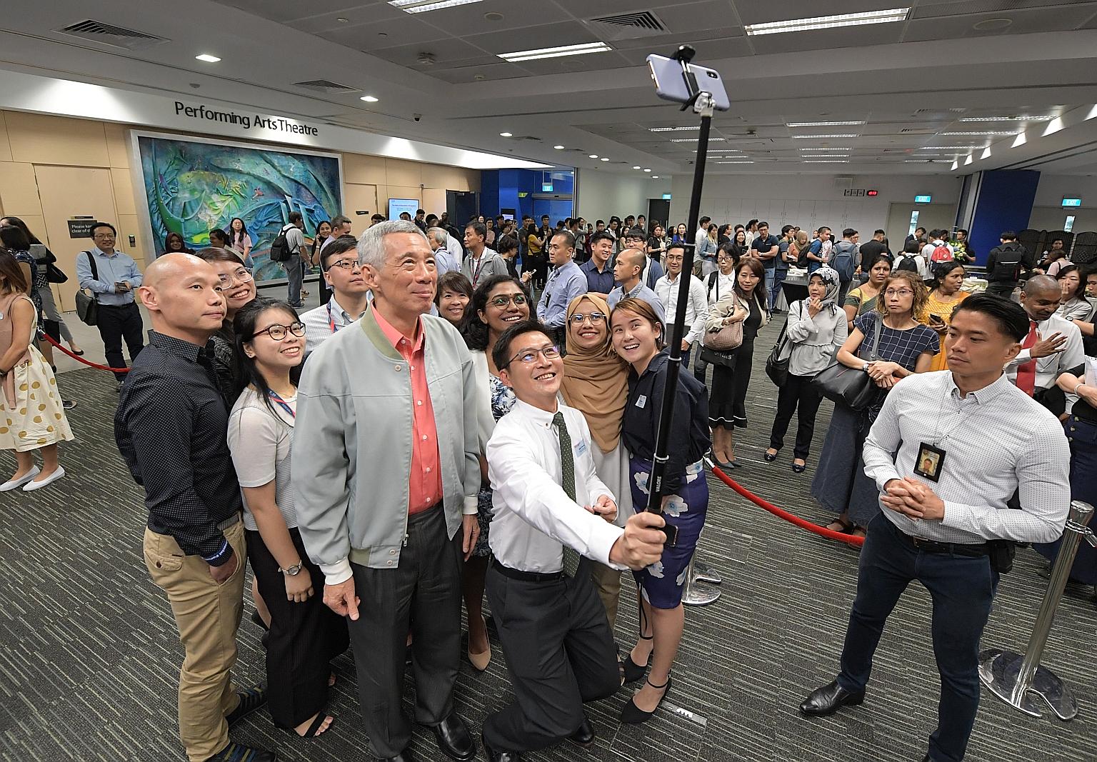 Prime Minister Lee Hsien Loong taking a photo with participants of the Singapore University of Social Sciences' inaugural ministerial dialogue. Among the issues covered during the dialogue were the value of lifelong learning and a university educatio