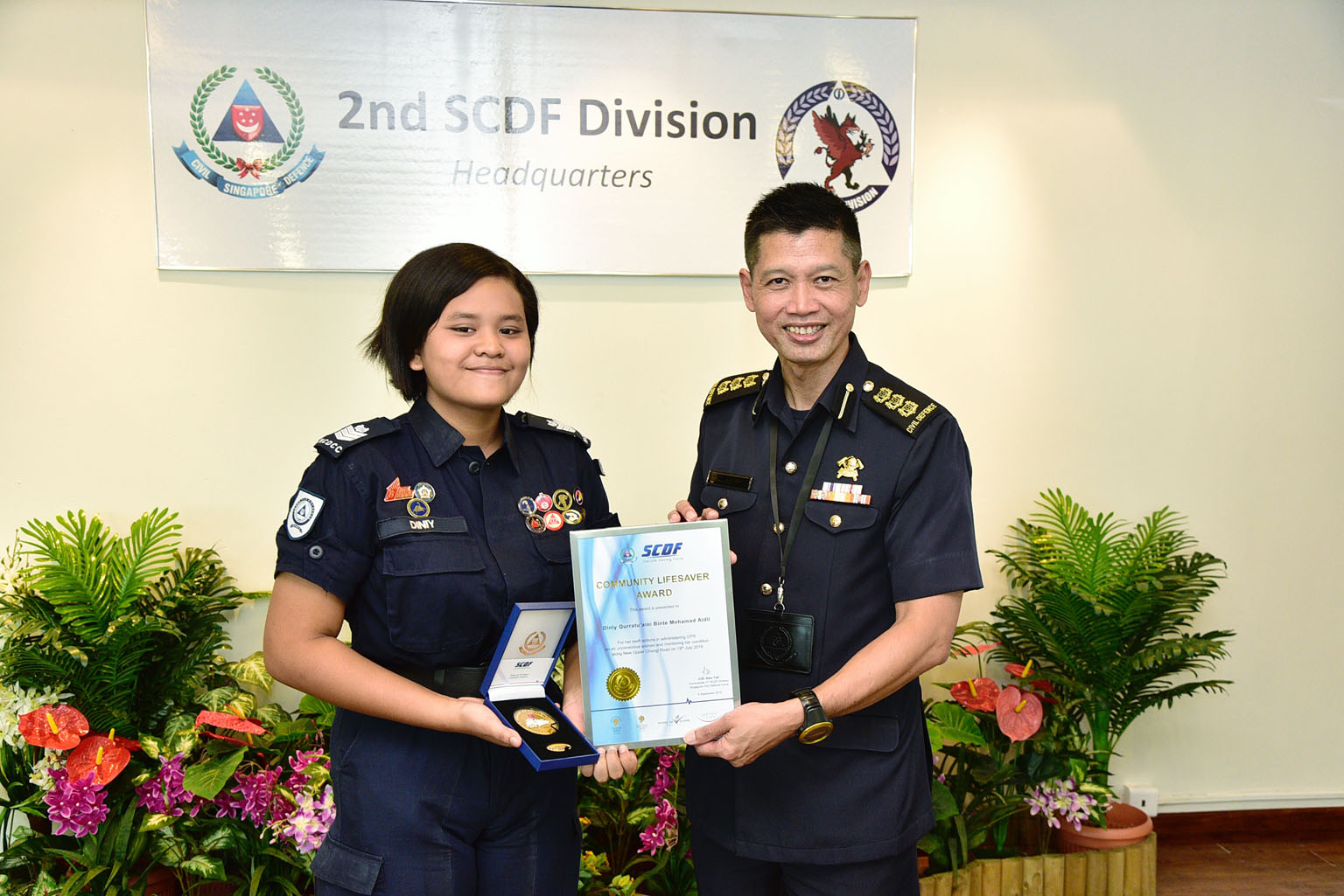 For her bravery and quick thinking in saving a woman who had been hit by a bus, student Diniy Qurratuaini received the Community Lifesaver Award from the Singapore Civil Defence Force yesterday at the 2nd SCDF Division Headquarters in Tampines. The 1