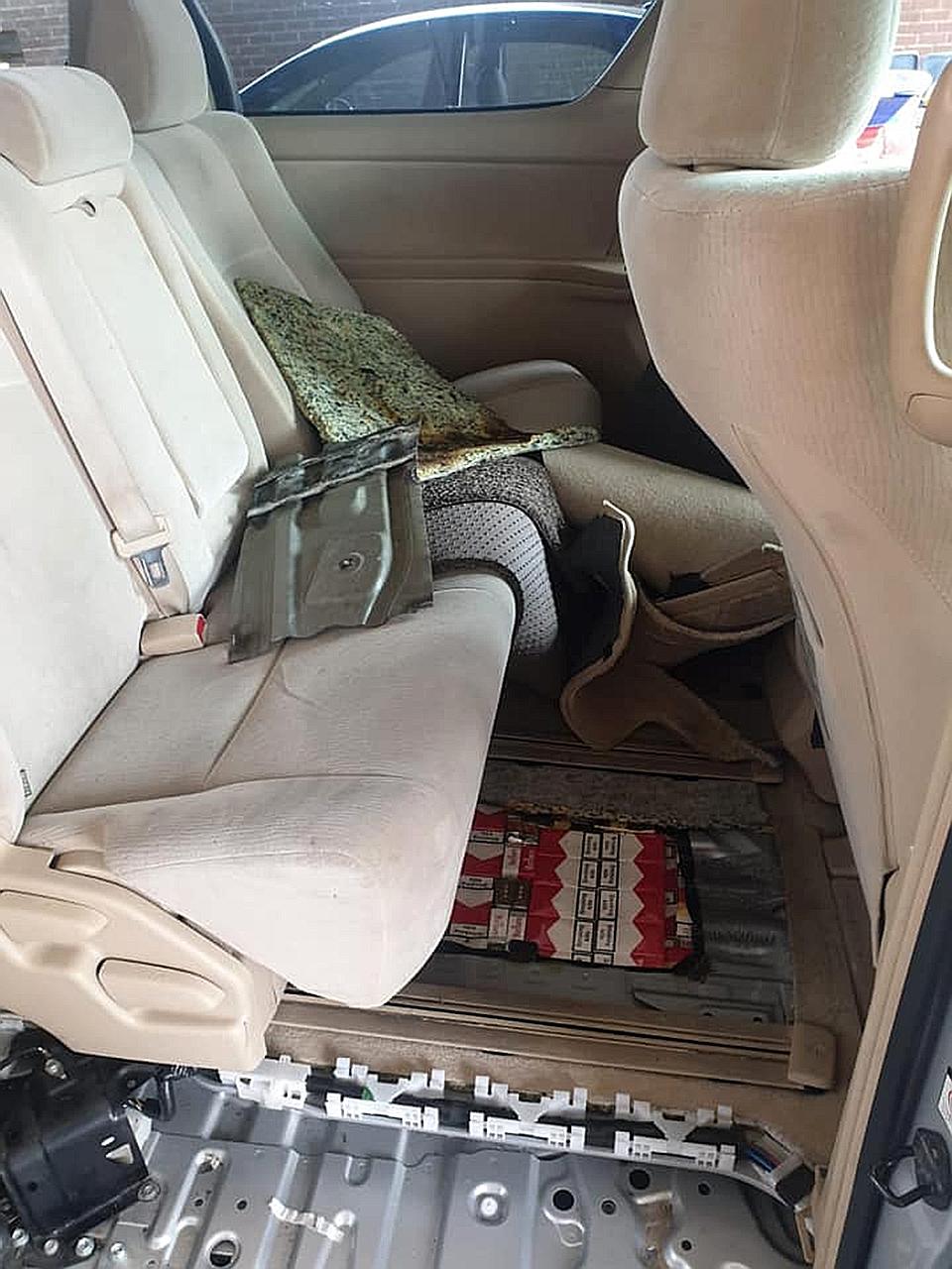 A total of 412 cartons and 640 packets of contraband cigarettes were concealed in a compartment of a car driven by a 27-year-old Malaysian on Sunday. PHOTO: ICA