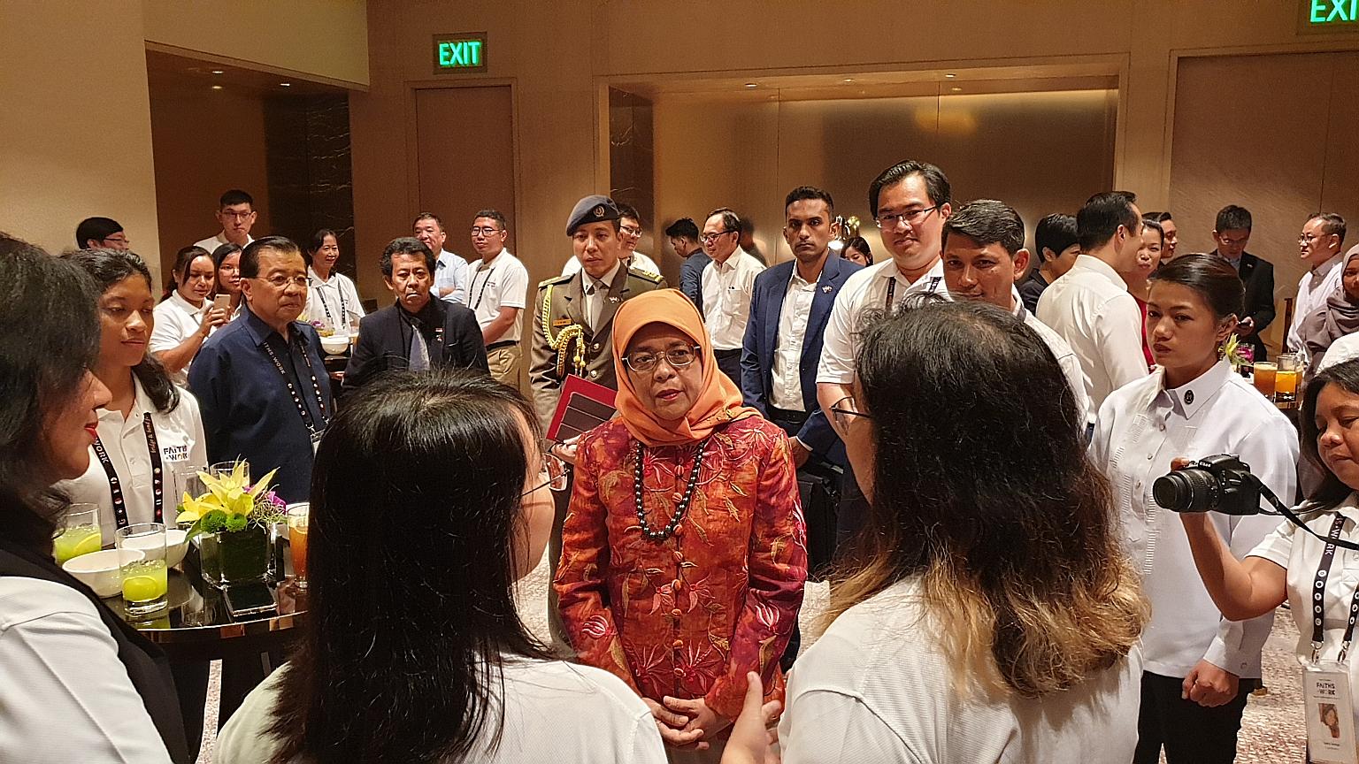 President Halimah Yacob meeting participants of Faiths@Work, a regional network that brings together South-east Asians of different faiths to do humanitarian work, in Manila yesterday. Dialogue is essential to counter prejudice, intolerance and ignor