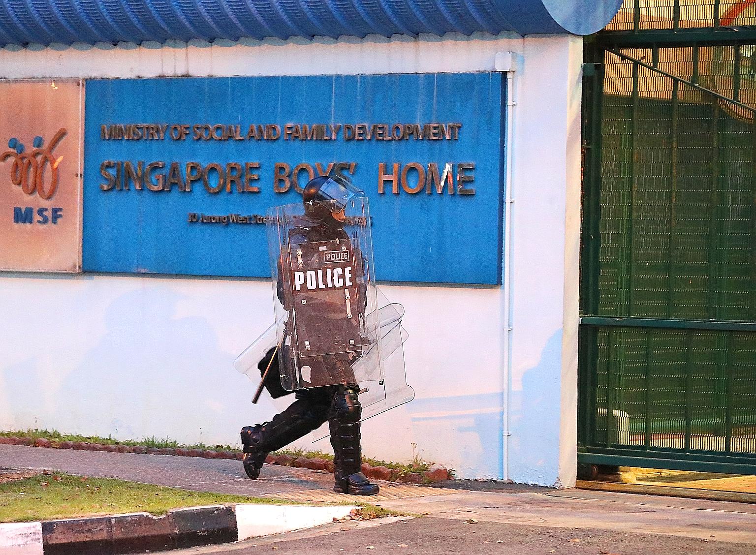 A police officer at the Singapore Boys' Home on Sept 28 last year, when the riot took place. An auxiliary police officer suffered an eye injury, while a youth guidance officer and the home's assistant manager had head injuries.