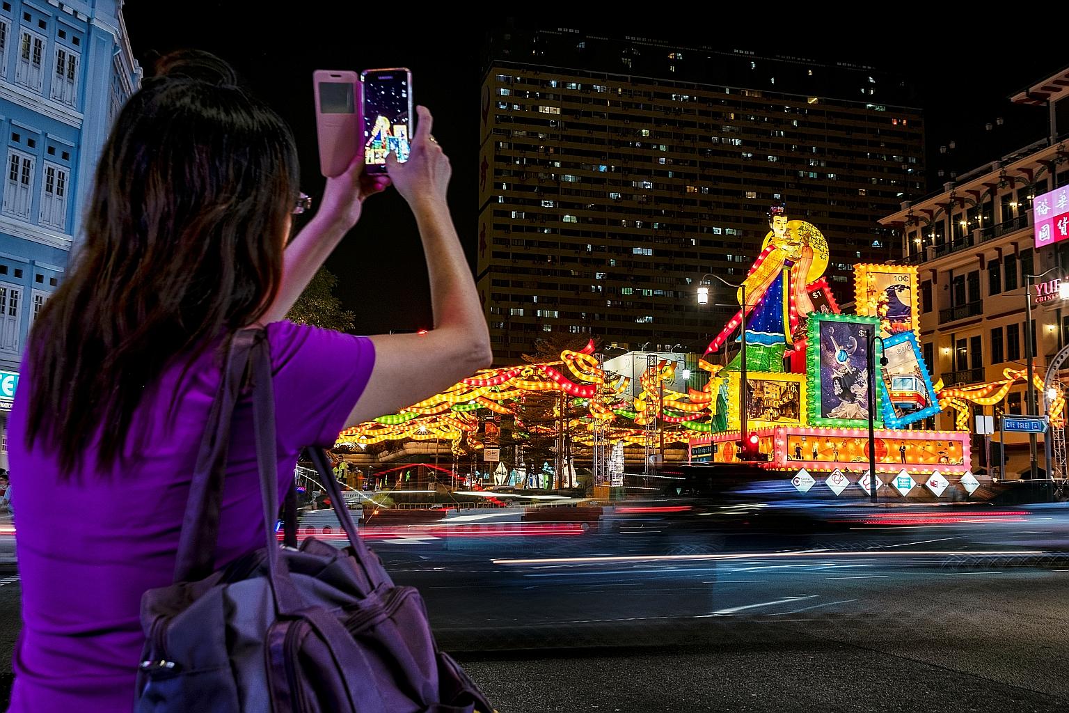 Giant lanterns depicting Chang'e, the goddess of the moon in Chinese mythology, and illuminated stamps light up a traffic junction in Chinatown. The lanterns, which line New Bridge Road, Eu Tong Sen Street and South Bridge Road, are part of the stree