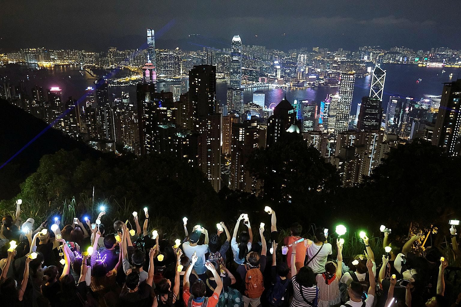 Hong Kong pro-democracy protesters took to the hills, including Victoria Peak, to form flashlight-carrying human chains last night, using the Mid-Autumn Festival as an occasion for their latest rally in more than three months of demonstrations that h