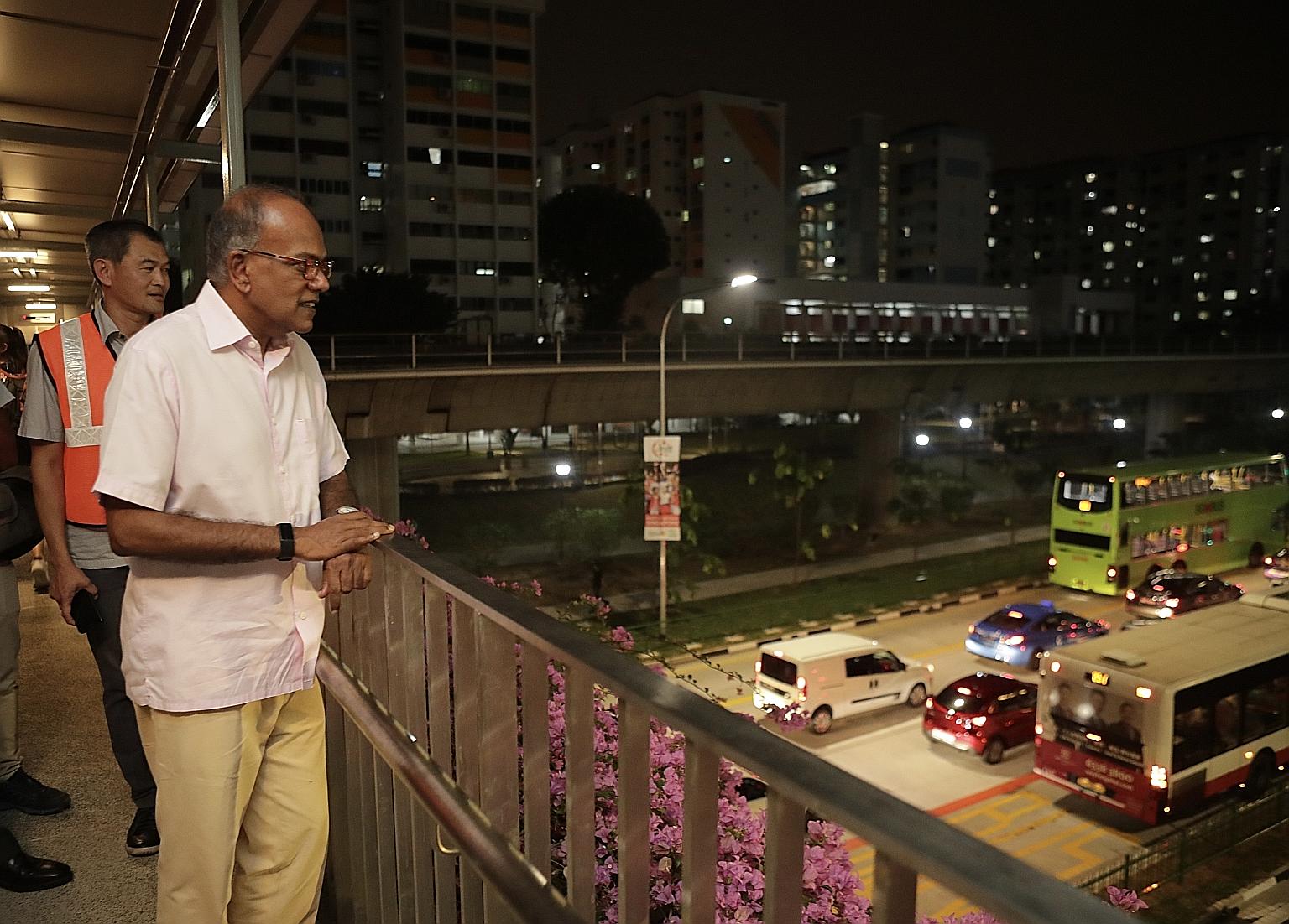 Law and Home Affairs Minister K. Shanmugam observing road conditions from an overhead bridge in Yishun Avenue 2 last night. Mr Shanmugam, seen here with Mr Lee Yong Heng, general manager of Mandai zone at SMRT Buses, was visiting the area around the 