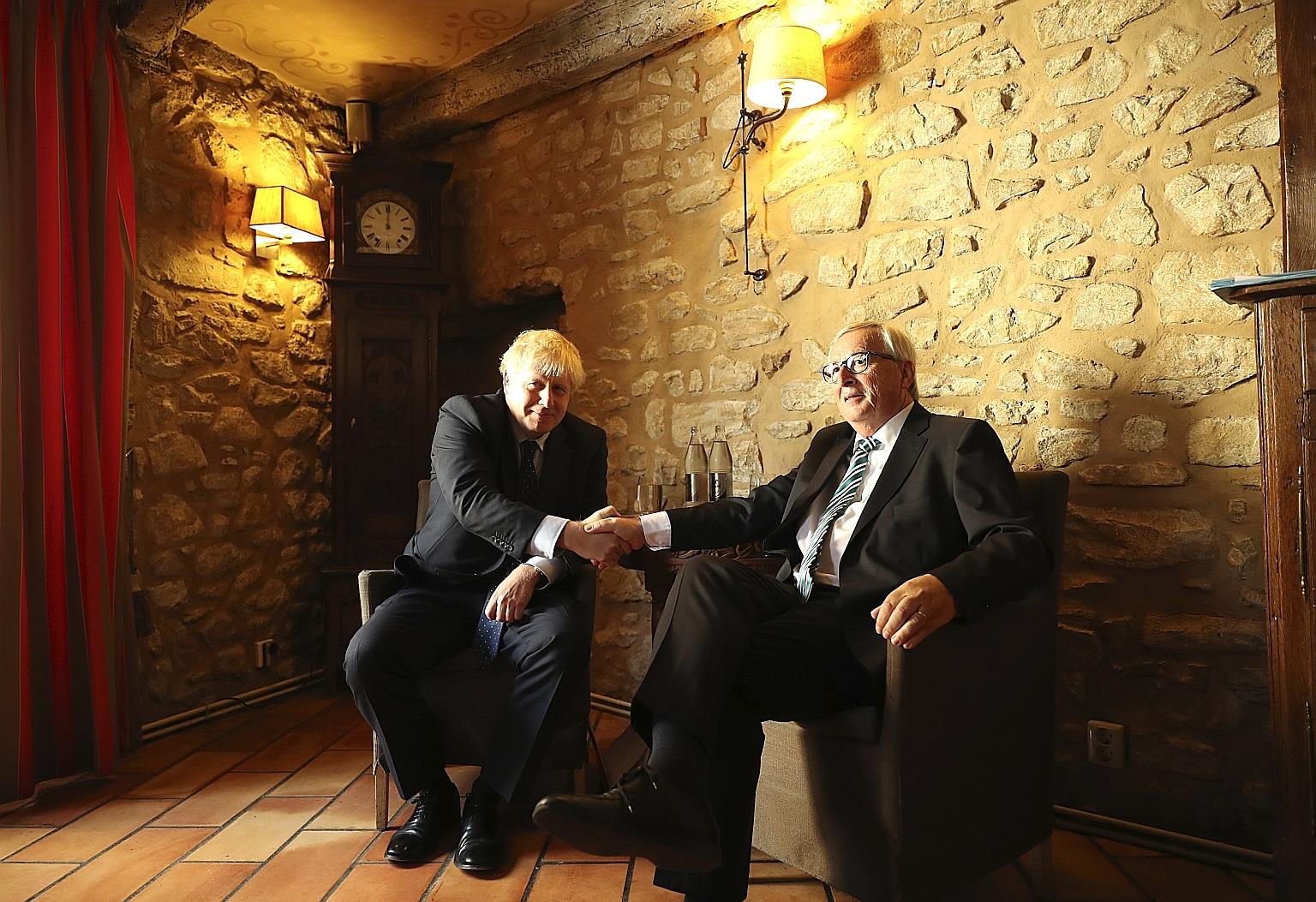 British Prime Minister Boris Johnson (left) and European Commission president Jean-Claude Juncker had their first face-to-face meeting over Brexit in Luxembourg yesterday. The two have offered starkly different assessments of the outcome of their tal