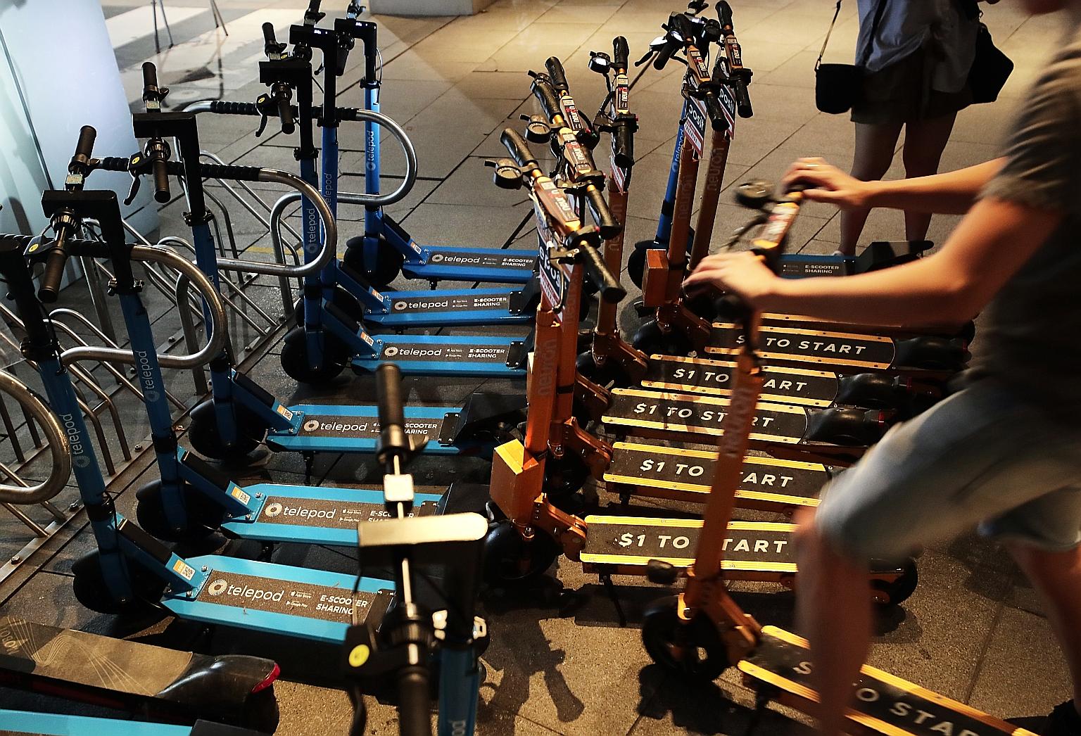 Telepod personal mobility devices (blue, above) and Neuron Mobility PMDs (orange) parked at Marina Bay Sands earlier this year. Both companies were charged under the Parking Places Act.