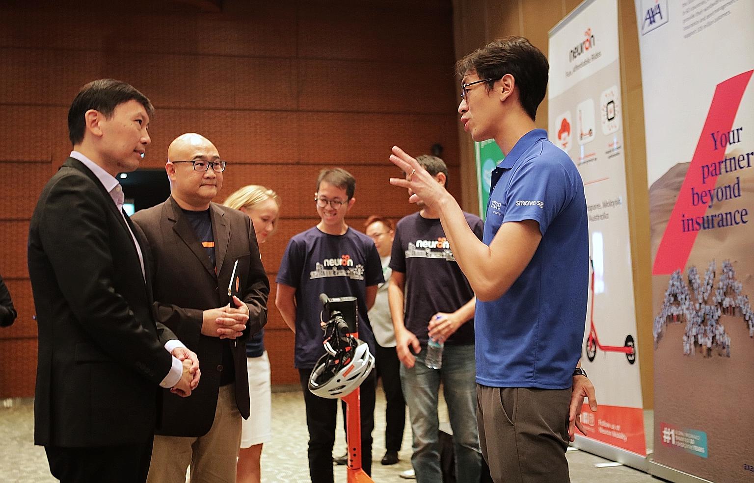 (From left) Senior Minister of State Chee Hong Tat and Mr Colin Lim, chief executive of mobilityX, speaking with Mr Joseph Ting, co-founder of car-sharing service Smove, at the official launch of Zipster at The Star Performing Arts Centre yesterday. 