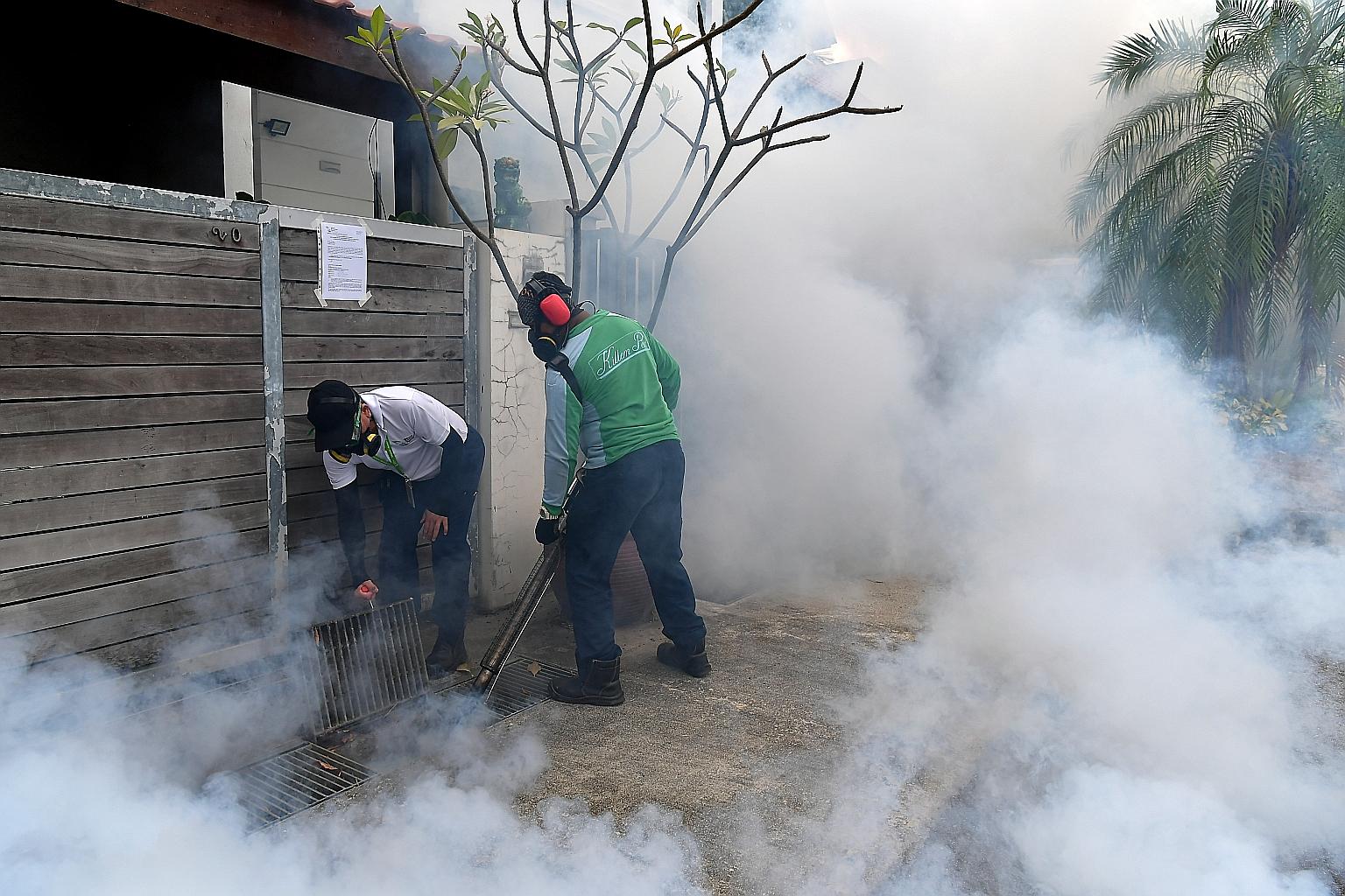 Pest control and National Environment Agency officers conducting fogging in Hemsley Avenue in Serangoon Gardens on Sunday. Three cases of locally transmitted Zika virus infection were confirmed in Hemsley Avenue last week, bringing the total number o