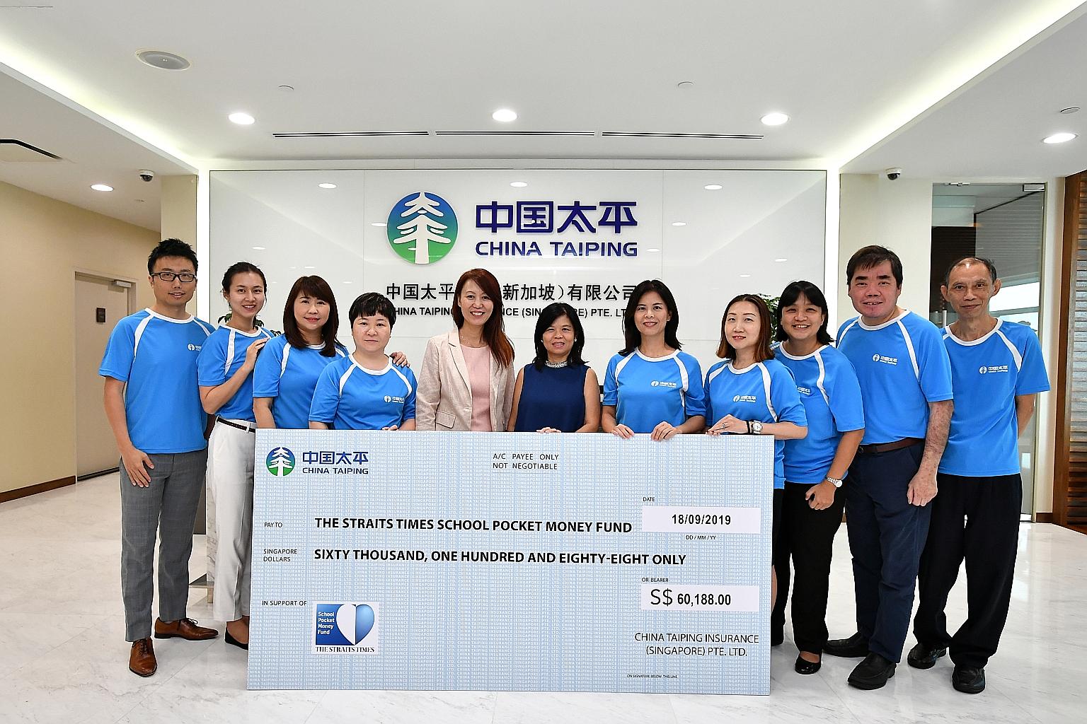 China Taiping Insurance Singapore deputy general manager Lynn Lee (fifth from left) presenting a cheque for $60,188 to STSPMF general manager Tan Bee Heong (centre) at China Taiping's office yesterday.