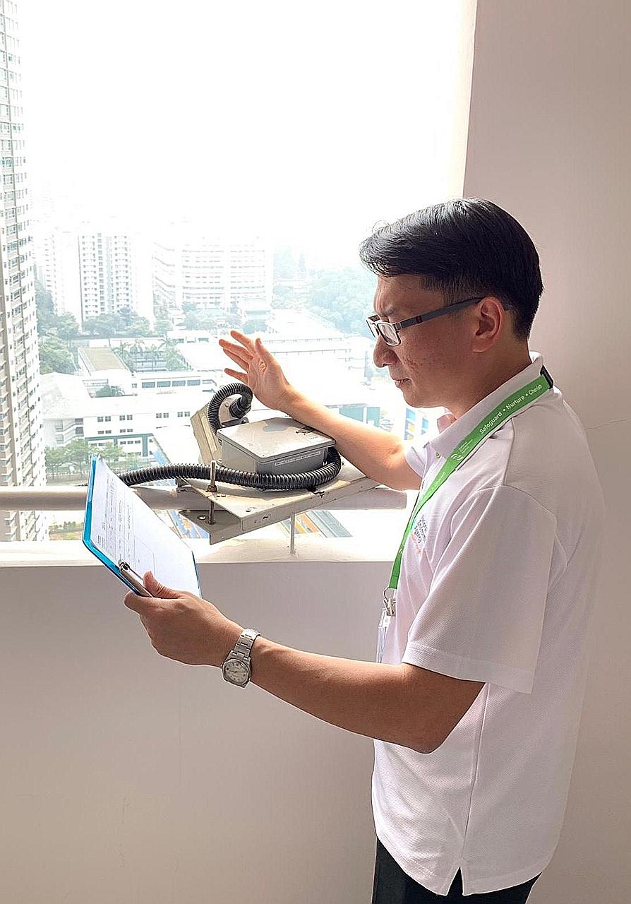 Mr Halmie Hussein Mattar with a camera used to investigate a high-rise littering case. When one area becomes a consistent concern, National Environment Agency officers may scope it out for suitable vantage points to place cameras. Investigators have 