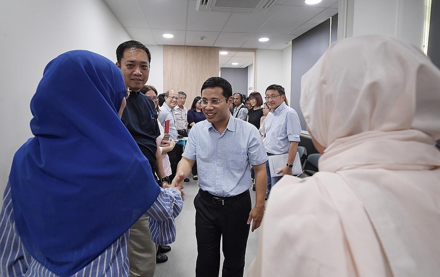 Minister for Social and Family Development Desmond Lee meeting divorce counsellors at the Ang Mo Kio Family Service Centre yesterday. He said judges needed to be empowered further to ensure disputes in divorce cases do not become a zero-sum game. ST 