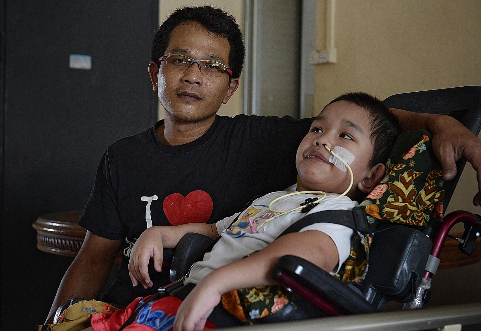 A January 2016 photo of Syahriz Matin Abdul Halim and his father Abdul Halim Abdul Aziz. The boy was found unresponsive and floating face down at the deeper end of the pool at the Civil Service Club in Bukit Batok in 2015. ST FILE PHOTO