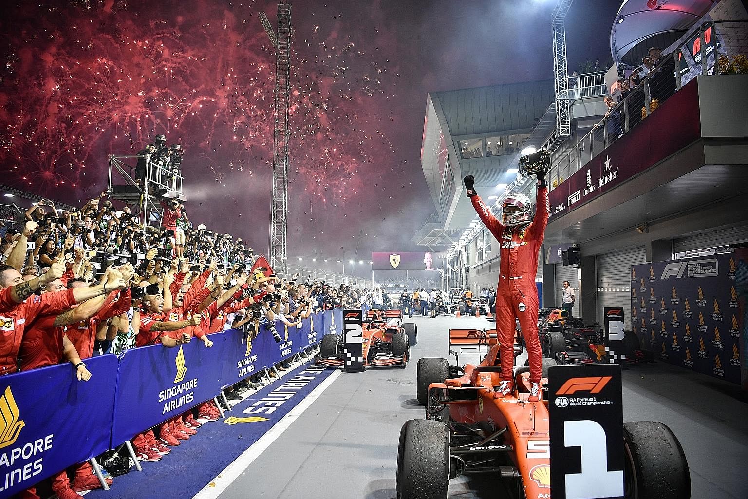 Ferrari's Sebastian Vettel celebrates after winning a record fifth title at the Singapore Airlines Singapore Grand Prix last night. The German four-time world champion started the 61-lap race in third place, before clinching top spot for his first ra