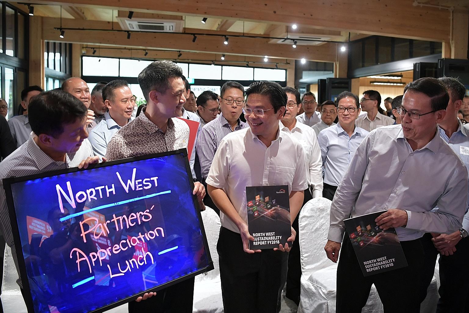 National Development Minister Lawrence Wong (centre) and North West District Mayor Teo Ho Pin (right) at yesterday's event to unveil the annual North West Sustainability Report, with North West District councillors Vincent Chong (left) and Michael La